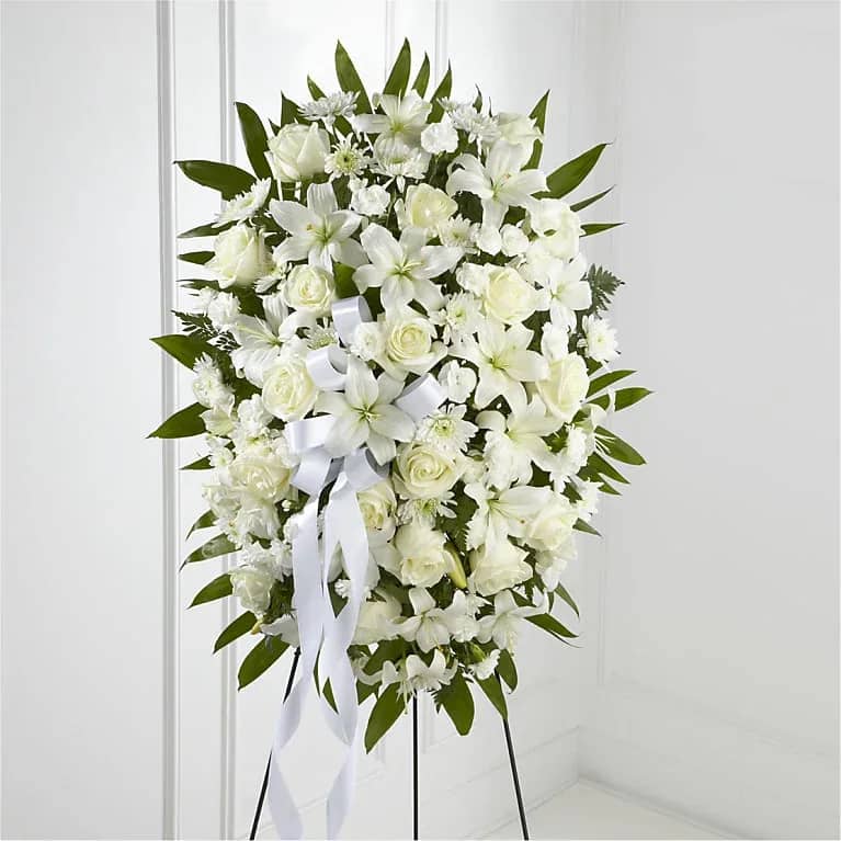Exquisite Tribute Standing Spray Exquisite Tribute Standing Spray - The FTD Exquisite Tribute Standing Spray is an elegant display of sweet serenity. White roses, Asiatic lilies, chrysanthemums and mini carnations are artfully arranged amongst emerald palm fronds and lush greens. Accented by white satin ribbon and standing on a wire easel, this standing spray is an outstanding way to honor the life of your loved one. FTD S4447p To allow for the freshest blooms possible, we may substitute for a different variety or color of flower.