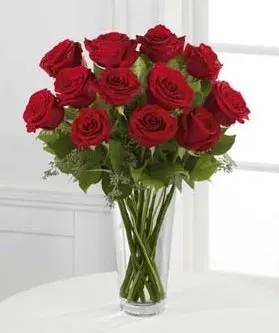 The Red Rose Bouquet - Nothing speaks of love so much as a bouquet of beautiful long stem red roses. Arranged with seeded eucalyptus in a classic glass vase, this bouquet is a gift to her heart from yours.  approximately 18&quot;H x 12&quot;W.