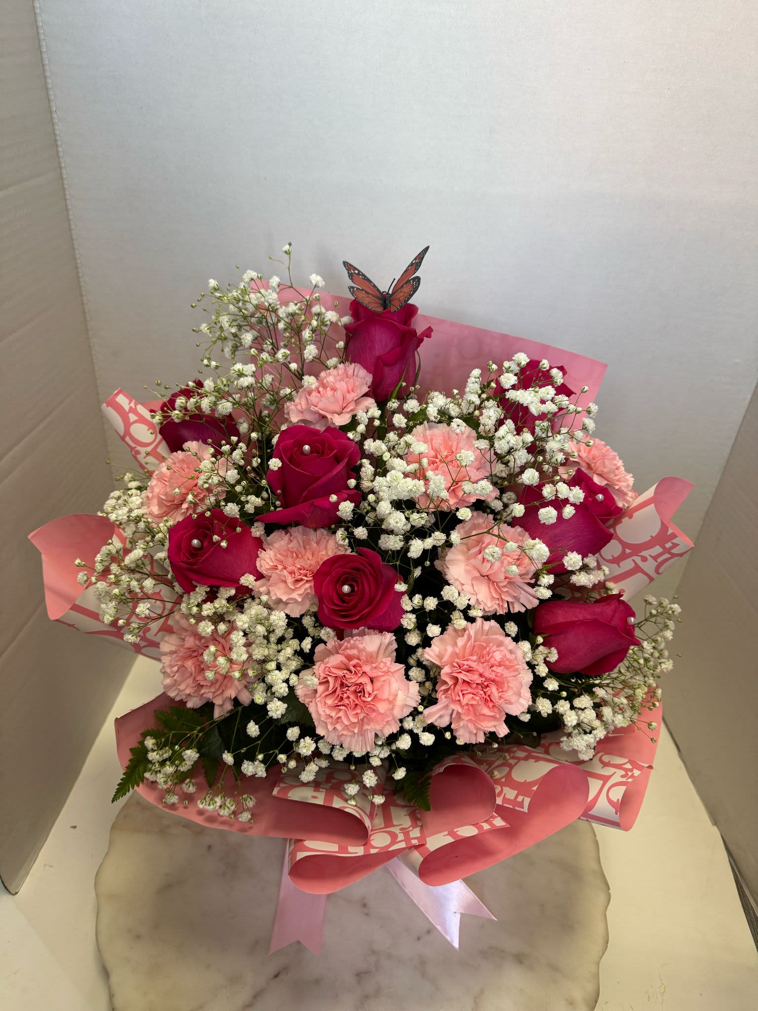 baby pink arrangement  - hot pink roses, pink carnations, baby's breath all in a piece of floral foam accompanied by Korean paper perfect for any occasion if you are looking for something different but modern!