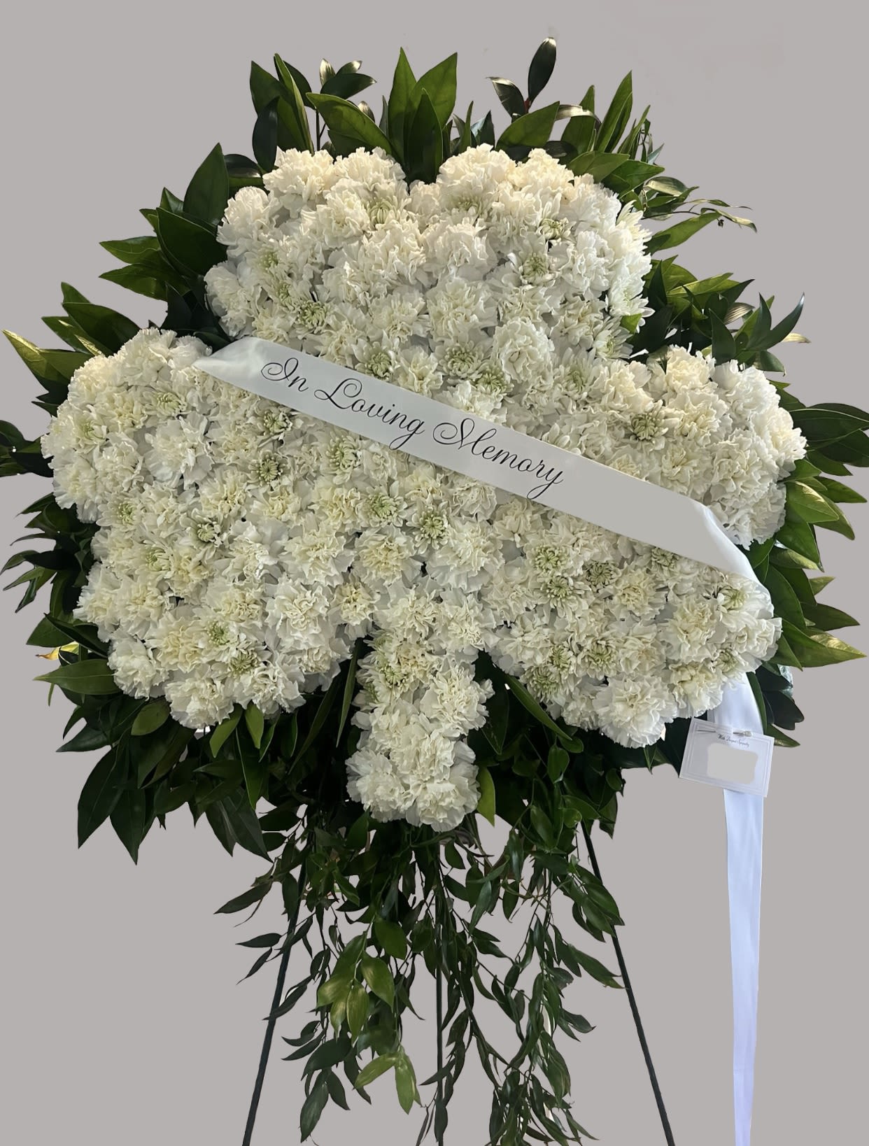 Everlasting Shamrock Funeral Wreath - Everlasting Shamrock Funeral Wreath  Celebrate the life and legacy of your loved one with the Everlasting Shamrock Funeral Wreath. Designed in the shape of a shamrock, this custom tribute symbolizes faith, hope, and love, making it a meaningful farewell for those with Irish heritage or a deep connection to this cherished symbol.  Crafted with fresh blooms, including elegant white flowers, this wreath represents peace, purity, and eternal remembrance. We offer custom funeral designs to create a tribute that honors your loved one in a personal and heartfelt way.  Contact us today to customize your arrangement.