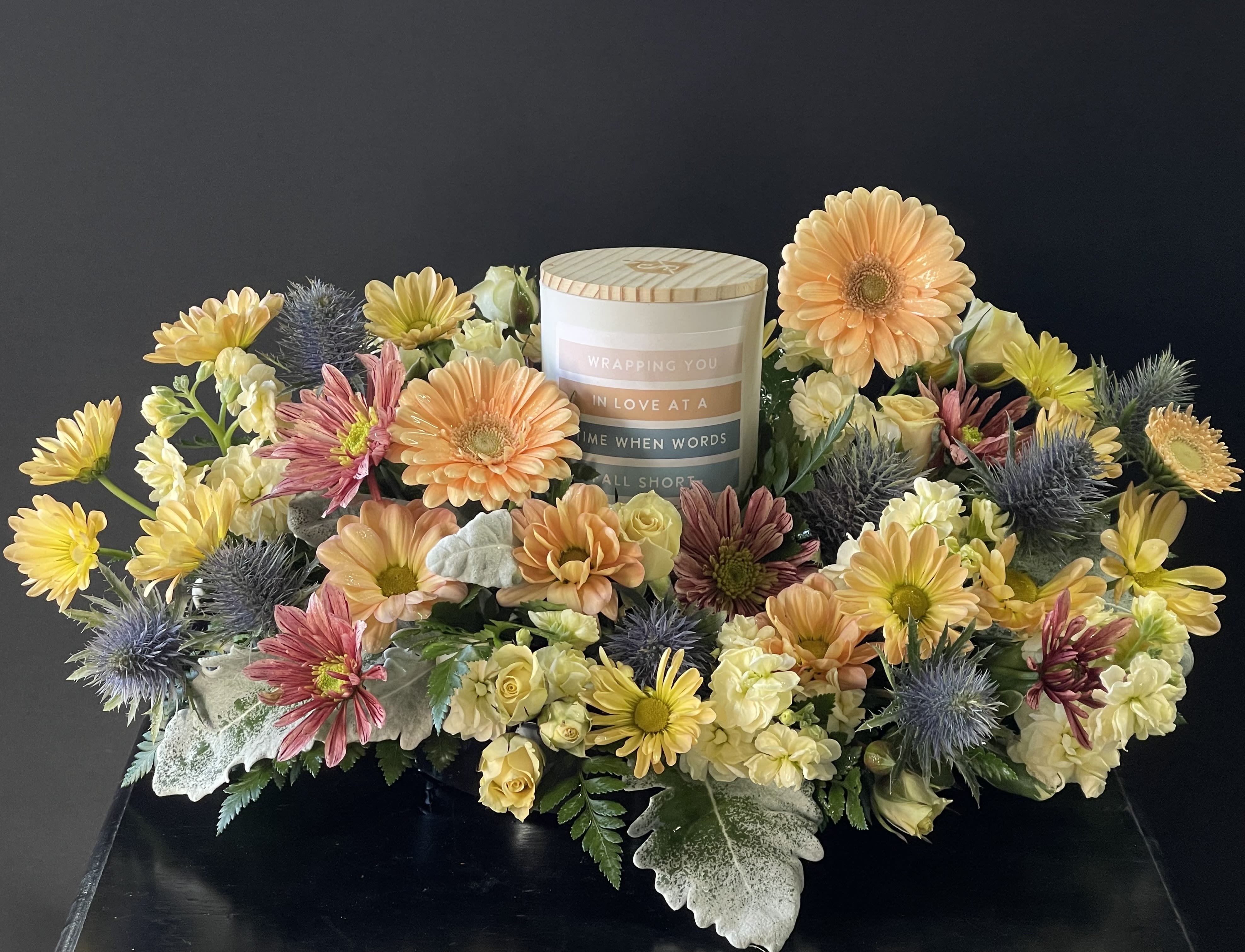 Sympathy Candle with Flowers - Candle reads “Wrapping you in love at a time when words fall short” Scent is Strawberry Cream. We do our best to match the photo, but we most likely will have to follow the color scheme, more than use the exact flowers in photo.  If you have specific flowers you want, let us know in the comments”Special Instructions “ at checkout or call direct.  It also helps if you order a few days in advance.