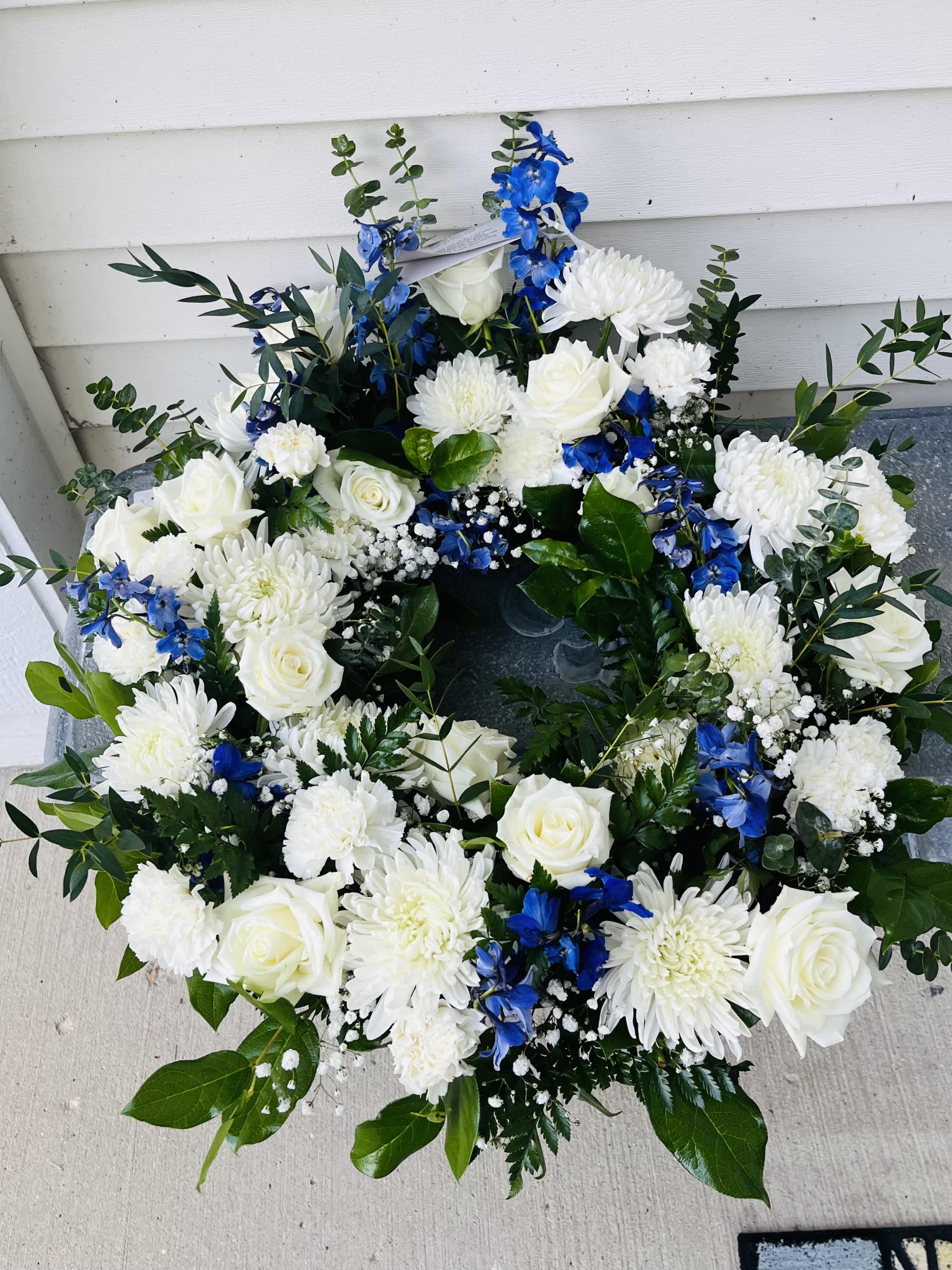 Cremation Wreath Cremation Wreath - Color of choice; roses, mums, and other beautiful blooms with fillers and greens. Standard 18" wreath. Leave colors of choice in comment box