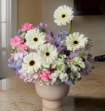 Ethereal Pastel Floral Arrangement  - Elevate any space with this delicate pastel bouquet, featuring white gerbera daisies, soft pink and lavender florals, and light blue accents, elegantly arranged in a modern ceramic vase. This luxury floral arrangement is a perfect blend of romance, sophistication, and timeless charm, making it an ideal choice for gifting, home décor, and special celebrations.   Premium fresh seasonal flowers in a soft pastel palette  Perfect for birthdays, anniversaries, Mother’s Day, and thoughtful gifts  Luxury floral décor for homes, offices, weddings, and special events  An elegant floral gift to express love, gratitude, and appreciation  Designed for modern aesthetics – soft, dreamy, and graceful  Same-day flower delivery in Los Angeles   Infuse your surroundings with the serenity and beauty of this exclusive pastel floral arrangement.