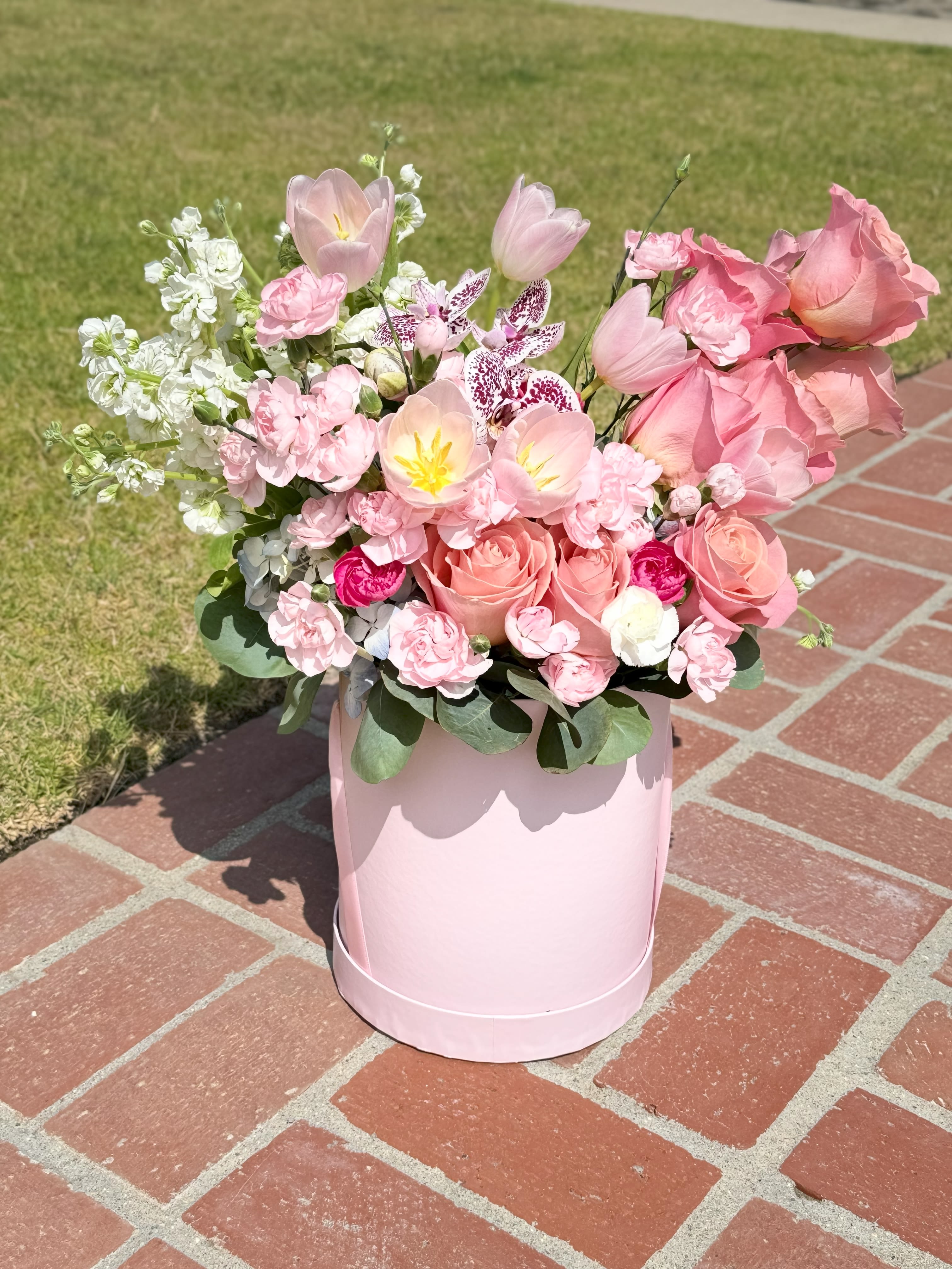 Los Angeles Dreams in Bloom - This elegant flower in a box features a stunning blend of tulips, roses, stock flowers, orchids, and carnations. Carefully arranged, each bloom creates a luxurious floral arrangement that brings freshness and sophistication to any space. Perfect as a gift flowers for any occasion, this luxury floral arrangement combines the beauty of fresh roses, vibrant tulips, fragrant stock flowers, delicate orchids, and charming carnations. Whether for a special event or as a floral centerpiece, this arrangement offers a timeless gift of beauty. Enjoy convenient flower delivery in Los Angeles with this unforgettable floral gift.