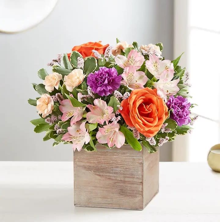Chic Garden™ Bouquet - EXCLUSIVE Chic meets sweet. Our new bouquet flaunts fresh spring style, gathered with a mix of coral, pink, peach and lavender blooms. Designed in our rustic, grey-washed wooden cube for a cool contrast of color, it’s like giving them their own gorgeous garden right at home.