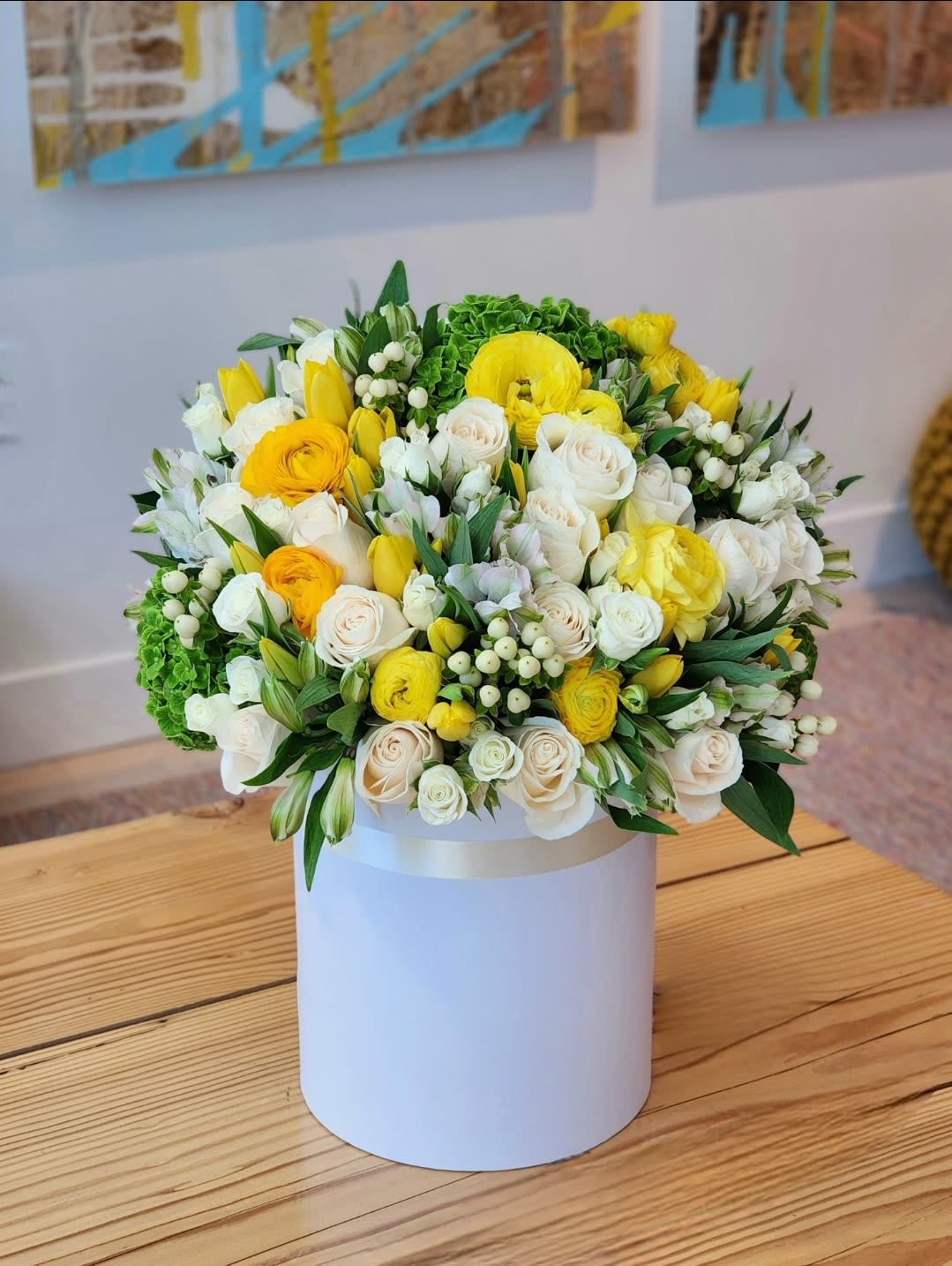 Spring Freshness  - This deluxe floral arrangement features a vibrant mix of yellow, green and white combination. A lively and cheerful display.  It's a stunning arrangement perfect for any joyous occasion.