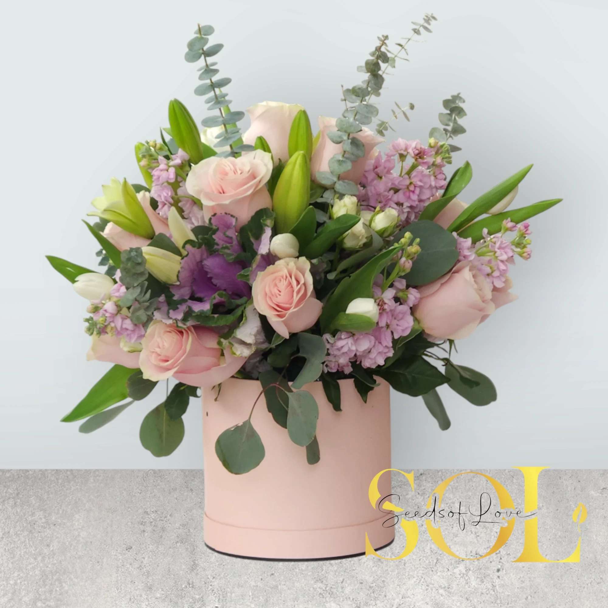 Isabel Blooming Box Isabel Blooming Box - A dozen of pink roses, pink stock, white spray roses, white lilies, baby eucalipto, silver dollar.