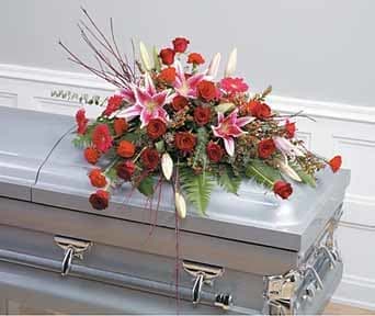 Rose and Lily Casket Spray Rose and Lily Casket Spray - This casket spray of roses and lilies arranged in a creative blend accented with assorted foliage and willow.
