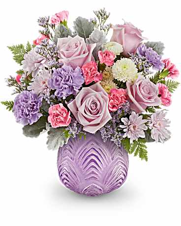 Dreamy Blooms Bouquet - Dreamy blooms! This stylish bouquet, featuring delicate pinks and shimmering lavenders, looks stunning in a sculpted glass vase with a contemporary art deco design. The Dreamy Blooms Bouquet features a lovely arrangement of light pink roses, lavender carnations, miniature pink carnations, and white button spray chrysanthemums. It is beautifully accented with pink cushion spray chrysanthemums, purple limonium, dusty miller, and leatherleaf fern, all delivered in the Dreamy Blooms Vase. Orientation: All-Around 