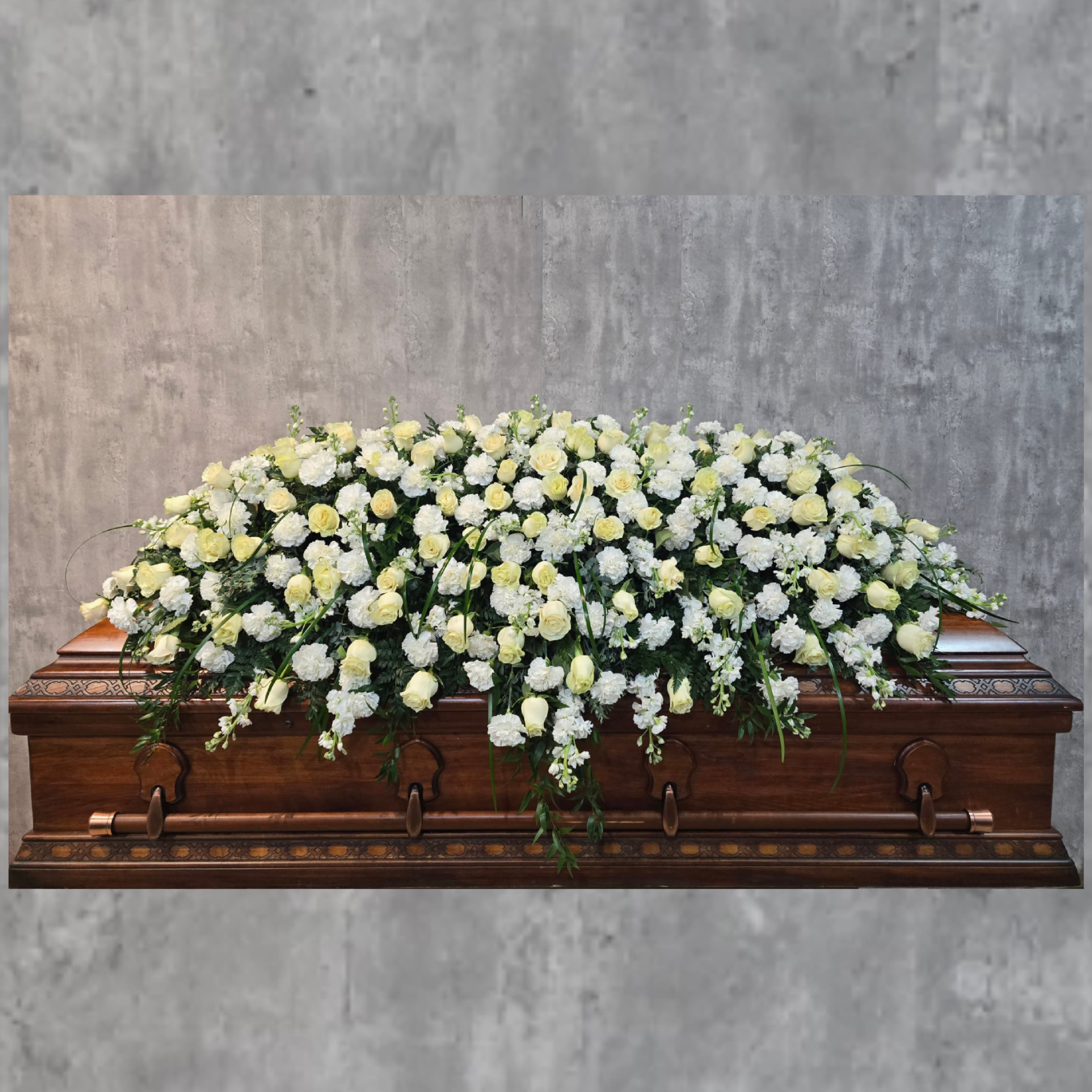Graceful Grandeur Casket Spray - This beautiful casket spray covers the entire casket when closed. This casket spray is made in 3 pieces so that the middle piece can be removed for viewing and the end pieces will fit nicely on the closed half of the casket. 
