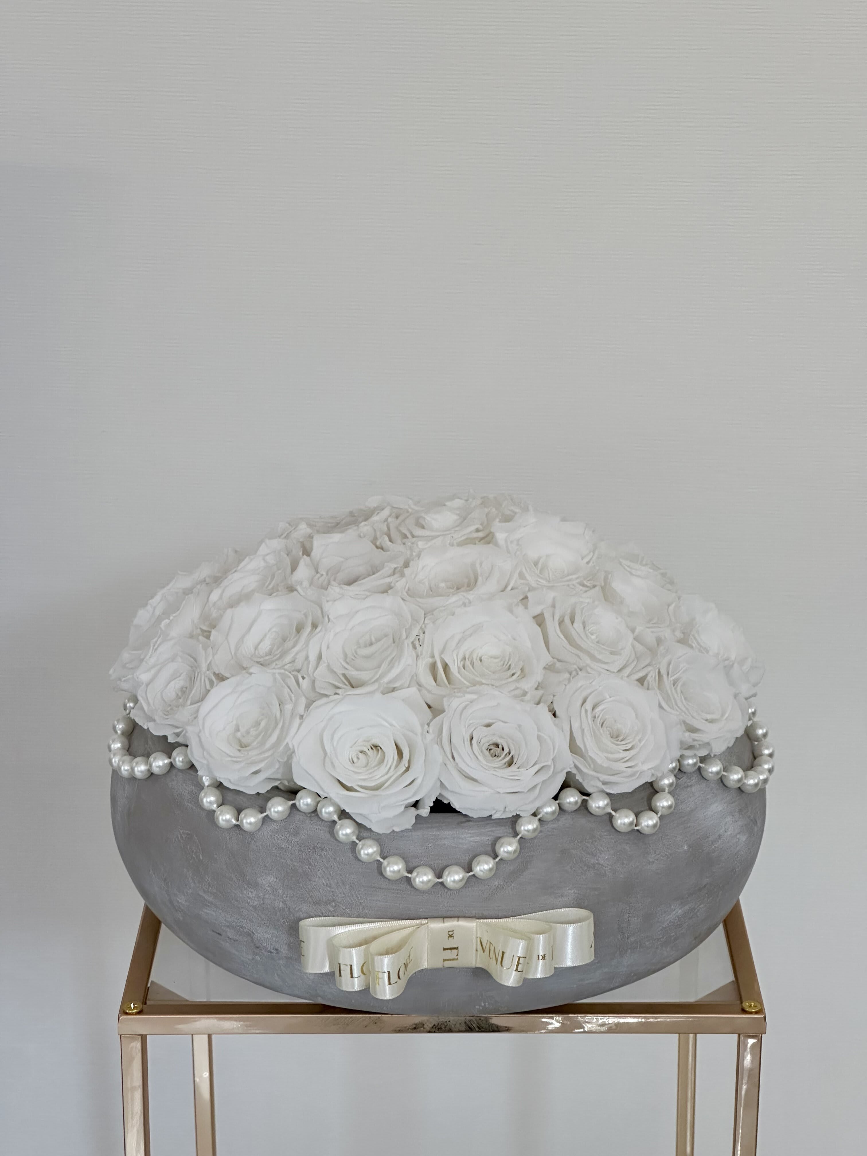 Preserved Timeless Elegance  - PRESERVED ROSES. Elevate any home decor with the modern elegance of this arrangement. A gift that transcends time, it brings a touch of timeless beauty to any space. Nestled within this chic vase are pristine white roses that have been carefully preserved to maintain their beauty and freshness for 1 year. 