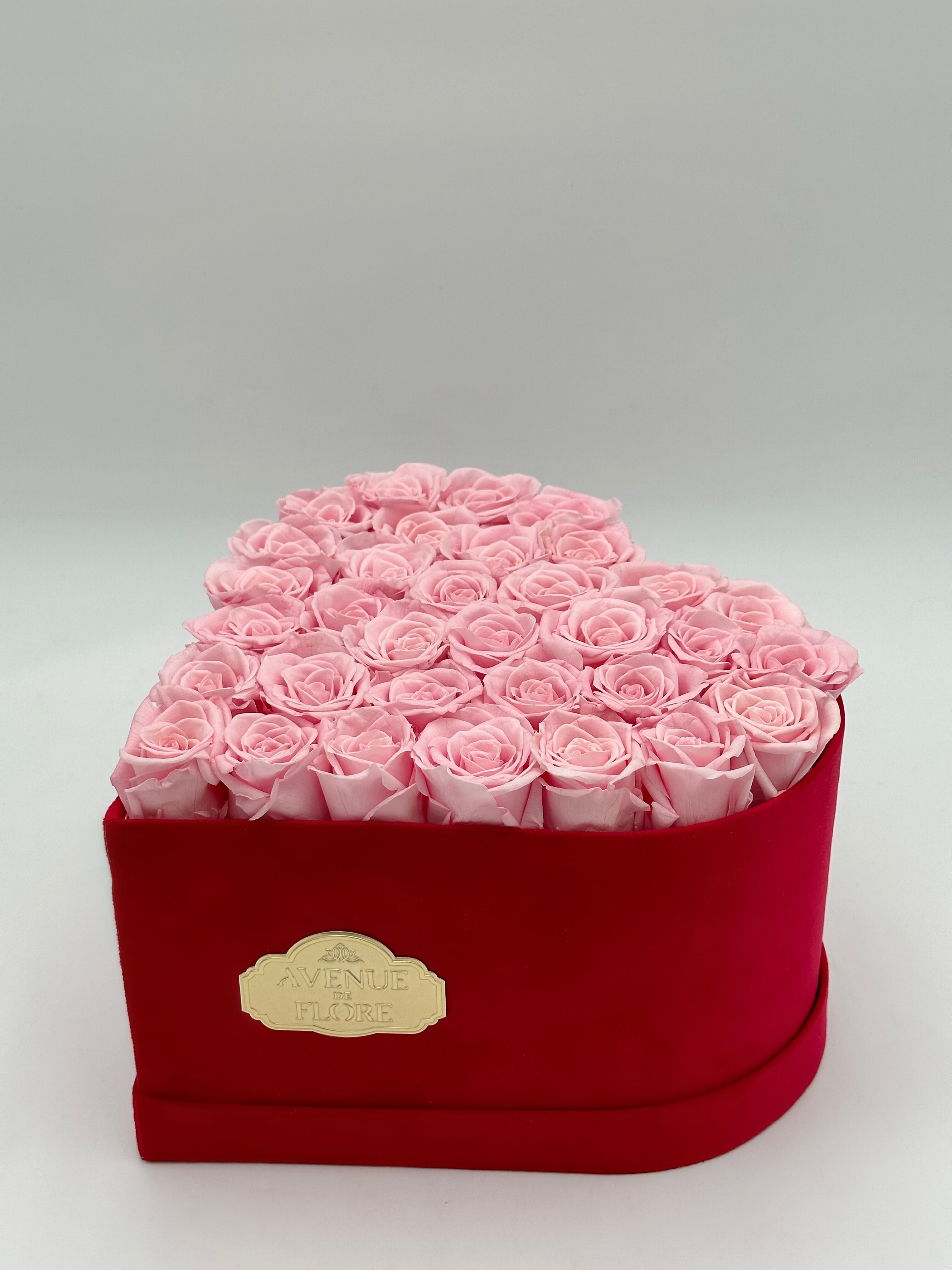 Pink Preserved Roses in Velvet Heart Box - PRESERVED ROSES. These pink roses, meticulously preserved to last for years, stand as a testament to everlasting affection. Nestled within a heart-shaped velvet box, this arrangement is a symbol of love, capturing the essence of romance that lasts for years. NOTE: The shade and size of pink roses may vary slightly from the image, depending on availability.