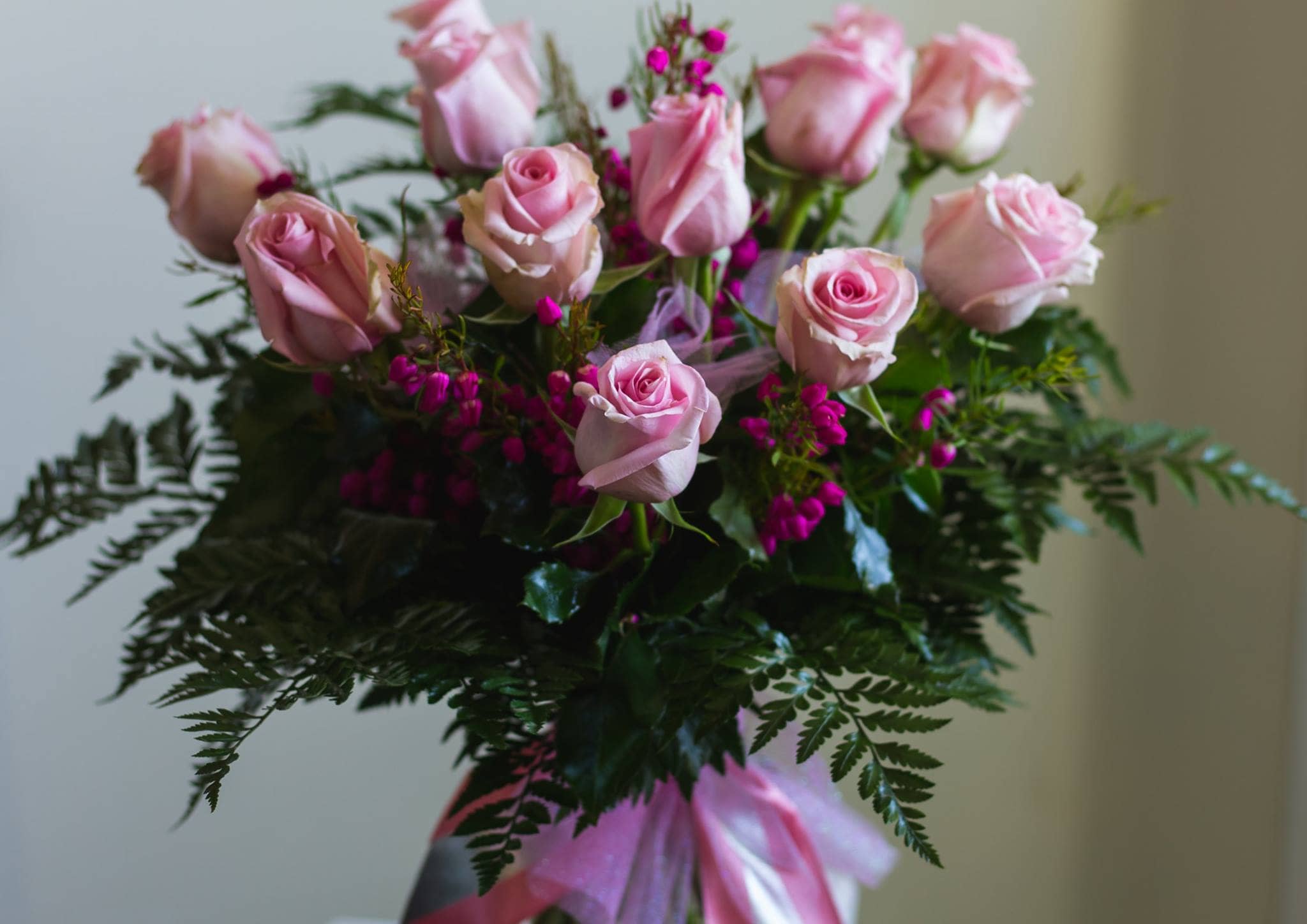 Premium Dozen Roses Premium Dozen Roses - Your choice of color, depending on availability-paired with greens, premium filler and ribbon. (includes one color of rose, only. Specific color requires 48 hours notice, please)