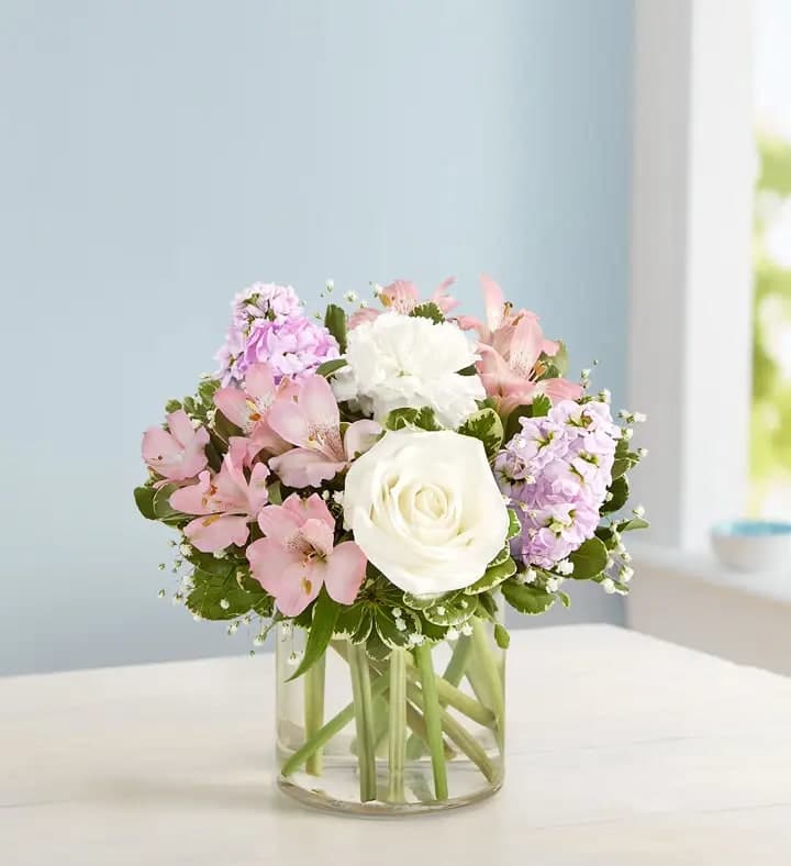 Elegant Blush™ Bouquet - Our elegant bouquet in shades of blush pink and creamy white brings all the charm of a rustic country garden to the people you care about. Cascading blooms are hand-gathered with lush greenery and designed in a clear cylinder vase, creating a beautiful gift that delights with every detail.
