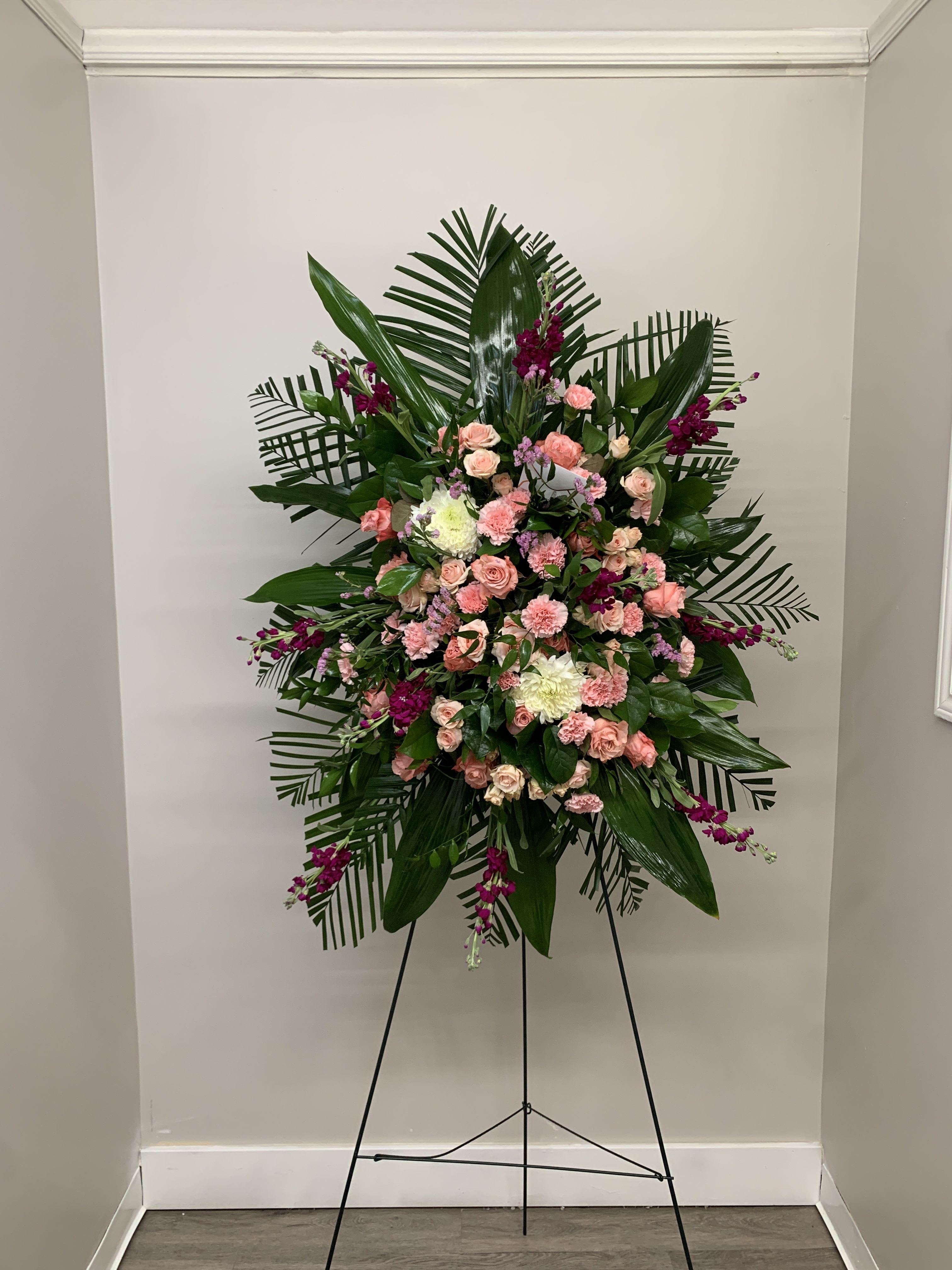 Pink Querida Amiga Standing Spray Pink Querida Amiga Standing Spray - Pink roses, pink spray roses, purple stock arranged in this beautiful standing spray.