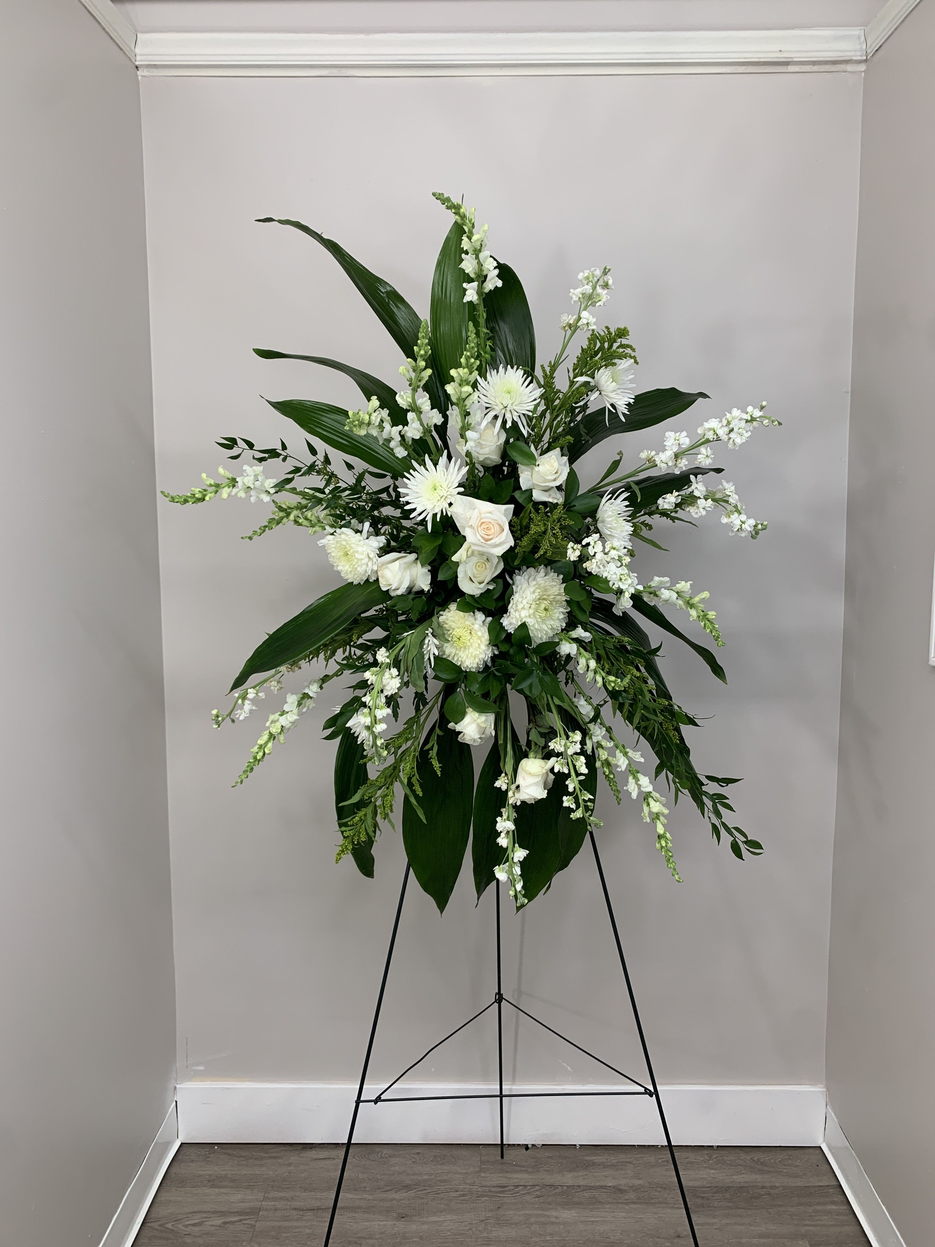White Standing Spray White Standing Spray - White roses, white stock and Pom poms arranged in this beautiful standing spray.