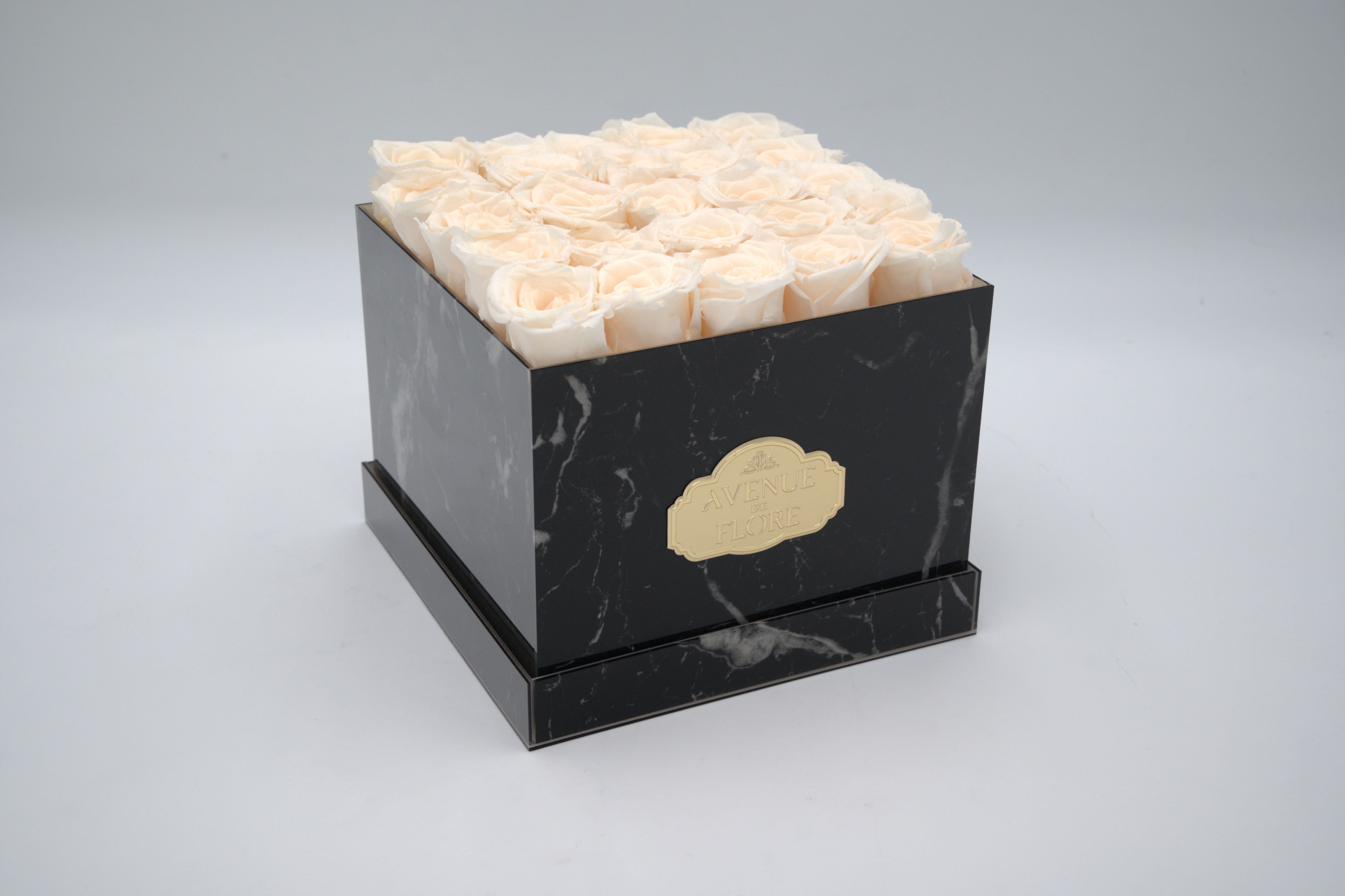 Black Marble Square Box - White Forever Roses Black Marble Square Box - White Forever Roses - Discover timeless elegance with our exquisite Black Marble box adorned with 25 ivory roses. The sleek black marble exterior enhances any space, while the meticulously crafted ivory roses gracefully last for years in all their magnificence. Perfect as a unique gift or a statement piece for your home decor. PRESERVED ROSES.