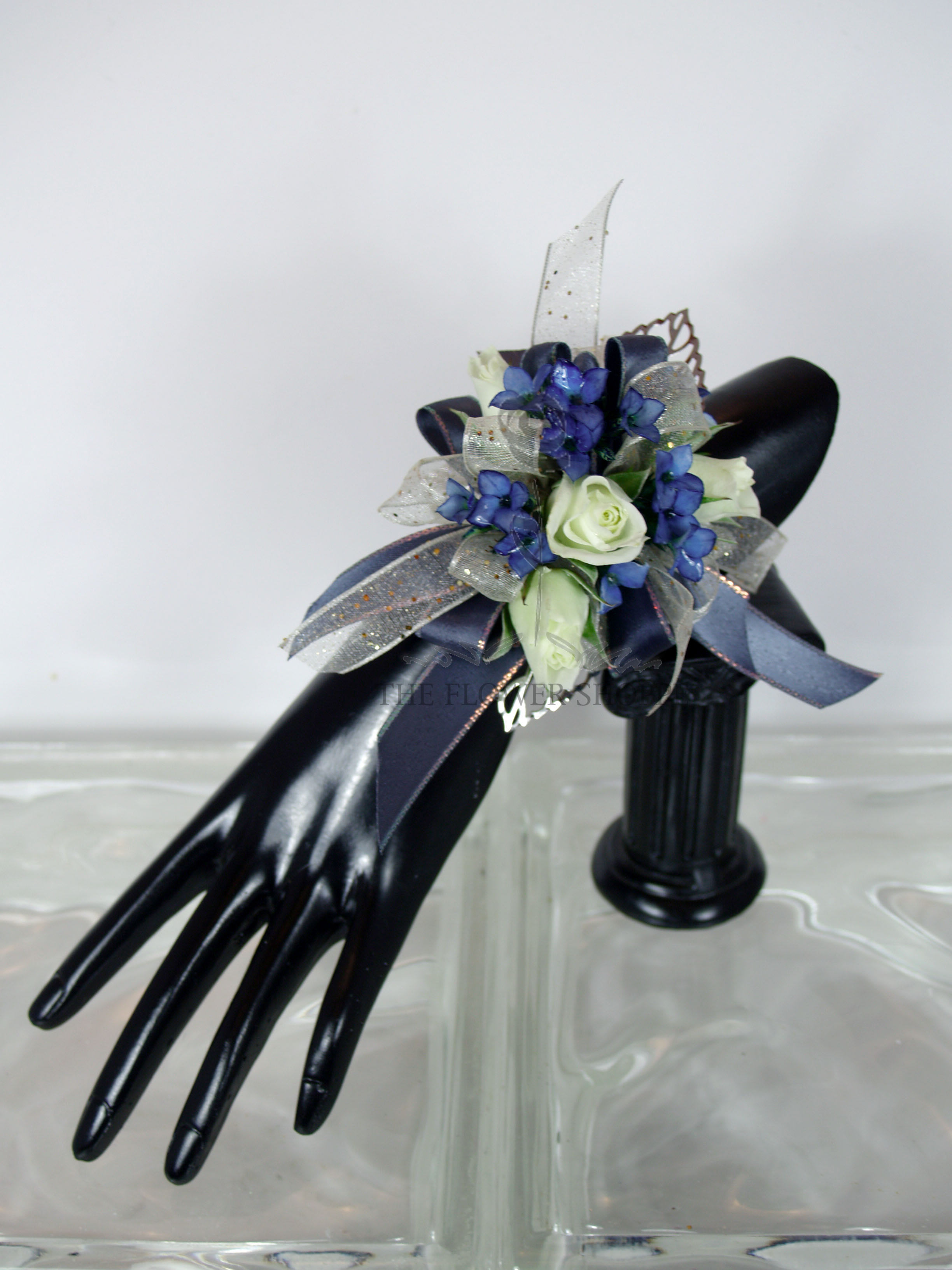 Blue and White Wrist Corsage Blue and White Wrist Corsage - White Roses with Blue Blossoms with a touch of gold accents