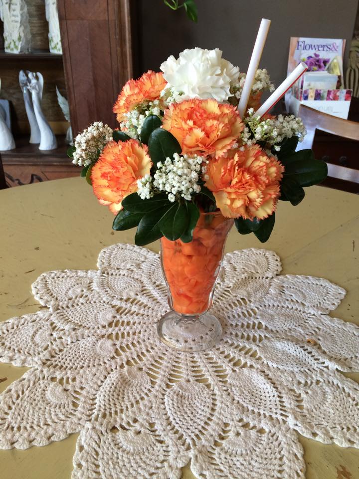 Eckert Florist's Orange Sorbet *LOCAL DELIVERY ONLY Eckert Florist's Orange Sorbet *LOCAL DELIVERY ONLY - Yum Yum! Doesn't this arrangement just look delicious?! Order a cute sorbet arrangement today and put a smile on someone's face!  Contains: Orange & white Dianthus, and Baby's breath. Flowers & Containers may vary depending on availability.