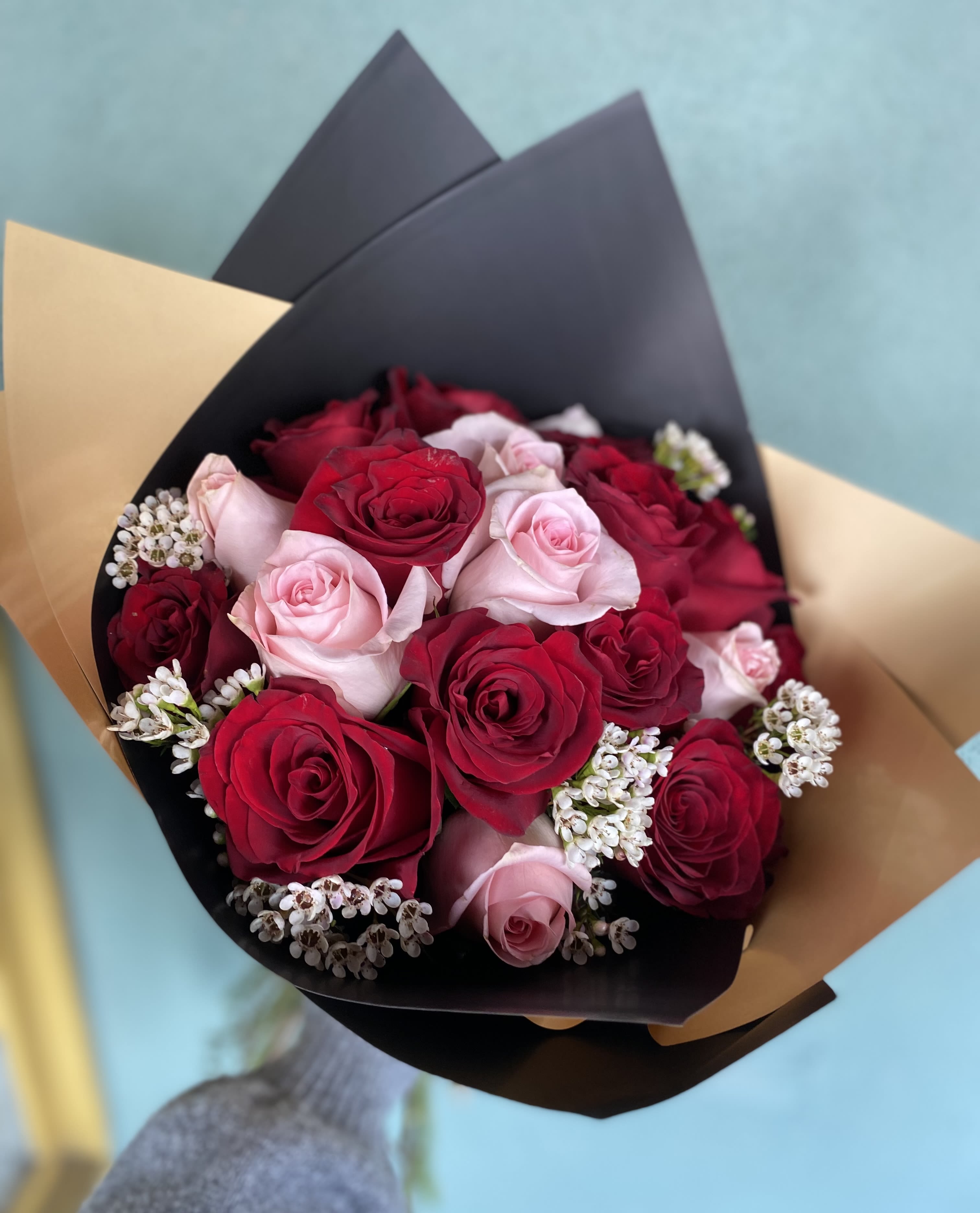 XOXO XOXO - Includes 18 red and pink roses with filler wrapped in black silk paper.