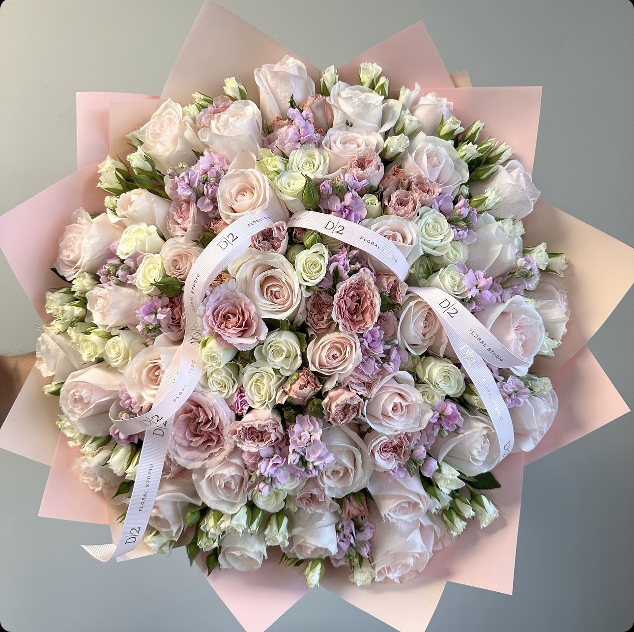 Agness Agness - A hand-tied pink bouquet showcases a delightful mix of soft and vibrant pink blooms, carefully gathered to create a charming and romantic arrangement. The bouquet features a blend of lush flowers like roses, peonies, or ranunculus, complemented by fresh greenery and delicate fillers. Tied with a ribbon, the stems are left exposed, adding a natural and elegant touch. The overall look is both graceful and informal, making it perfect for a gift or special occasion, radiating warmth and affection.