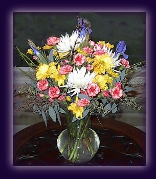 A Bit of Sunshine A Bit of Sunshine - Spread a little sunshine with the beautiful fresh cut. Made up of Spider Mums, Mini Carnations, Purple Iris and much more! Product ID: YR01