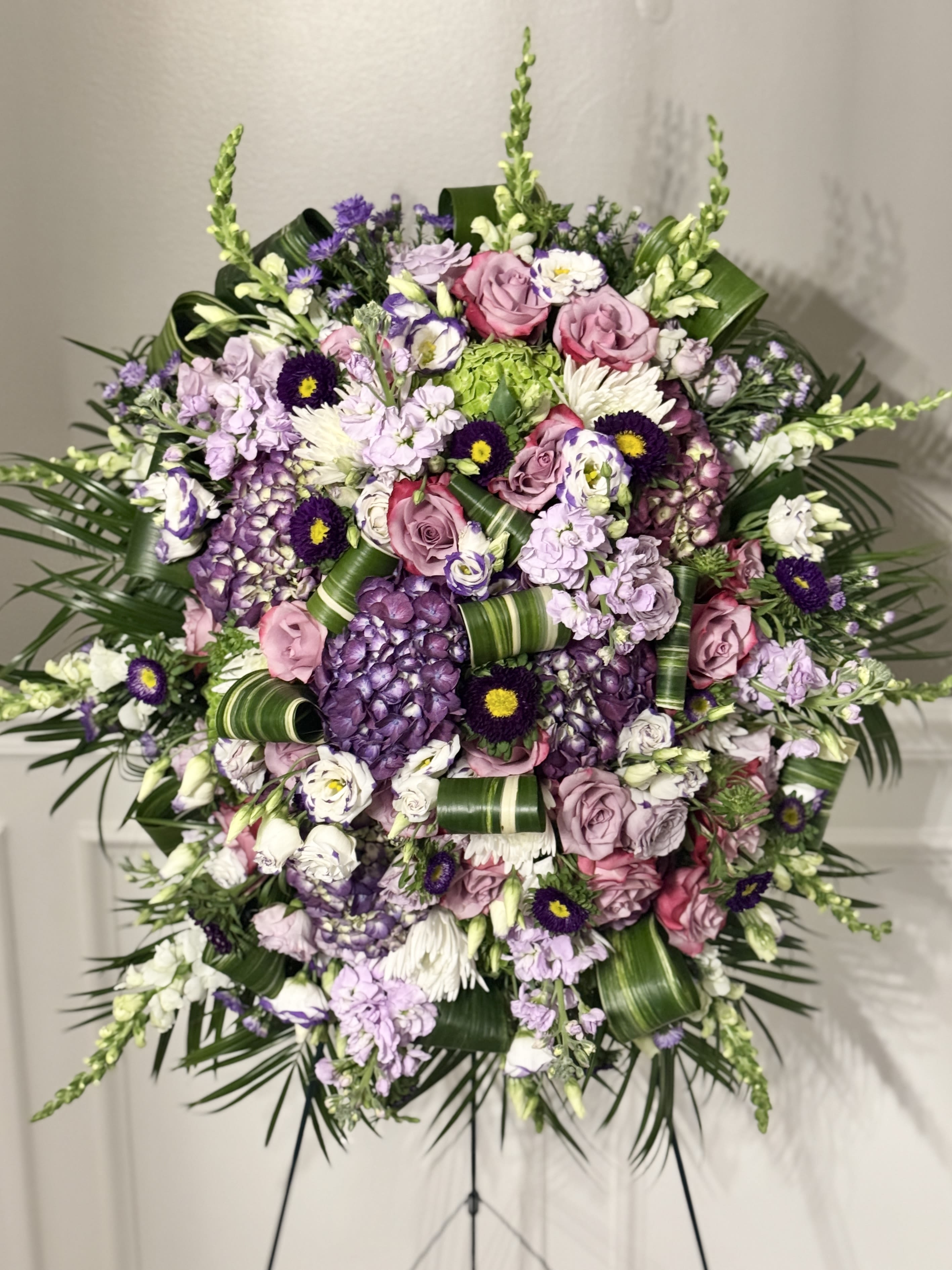 Florist's Pick Funeral Spray - A heartfelt tribute, crafted with care. Our Florist’s Pick Funeral Spray is a one-of-a-kind arrangement, designed with the freshest seasonal blooms hand-selected by our expert florists. Each spray is unique, offering a personalized expression of love and remembrance that stands apart from traditional designs.  What makes this spray special is its bespoke nature—no two arrangements are ever the same. We thoughtfully curate a harmonious blend of textures and colors, ensuring a stunning presentation that honors your loved one with beauty and grace. Whether you seek soft, comforting pastels or bold, vibrant hues, our artistry reflects the sentiment you wish to convey.  By trusting our florist’s expertise, you receive an elegant, standout piece that captures the essence of your tribute—thoughtful, meaningful, and truly unforgettable.
