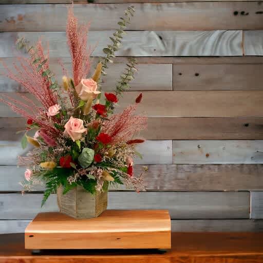 Boho Blooms In Reds and Pinks - This stunning arrangement is designed in an octagonal wooden container made from reclaimed wood. It includes wonderfully fresh flowers along with dried pampas grass and bunny tails. The foliage includes spiral eucalyptus, seeded eucalyptus, Italian Ruskus and more! The flowers may vary slightly based on availability, but the overall feel and composition of the arrangement will be similar to the photo. And if you prefer other colors, just indicate when you check out and we will choose the freshest flowers from our cooler to accommodate your request! 