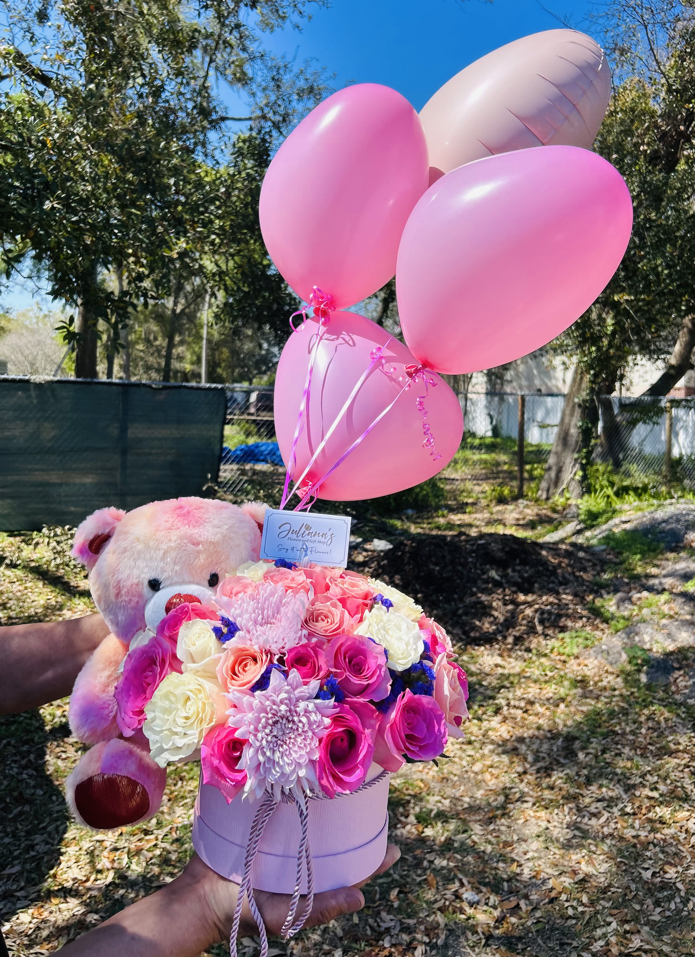 Medium round box  - Round box with assorted flowers in seasonal colors, teddy bear and balloons