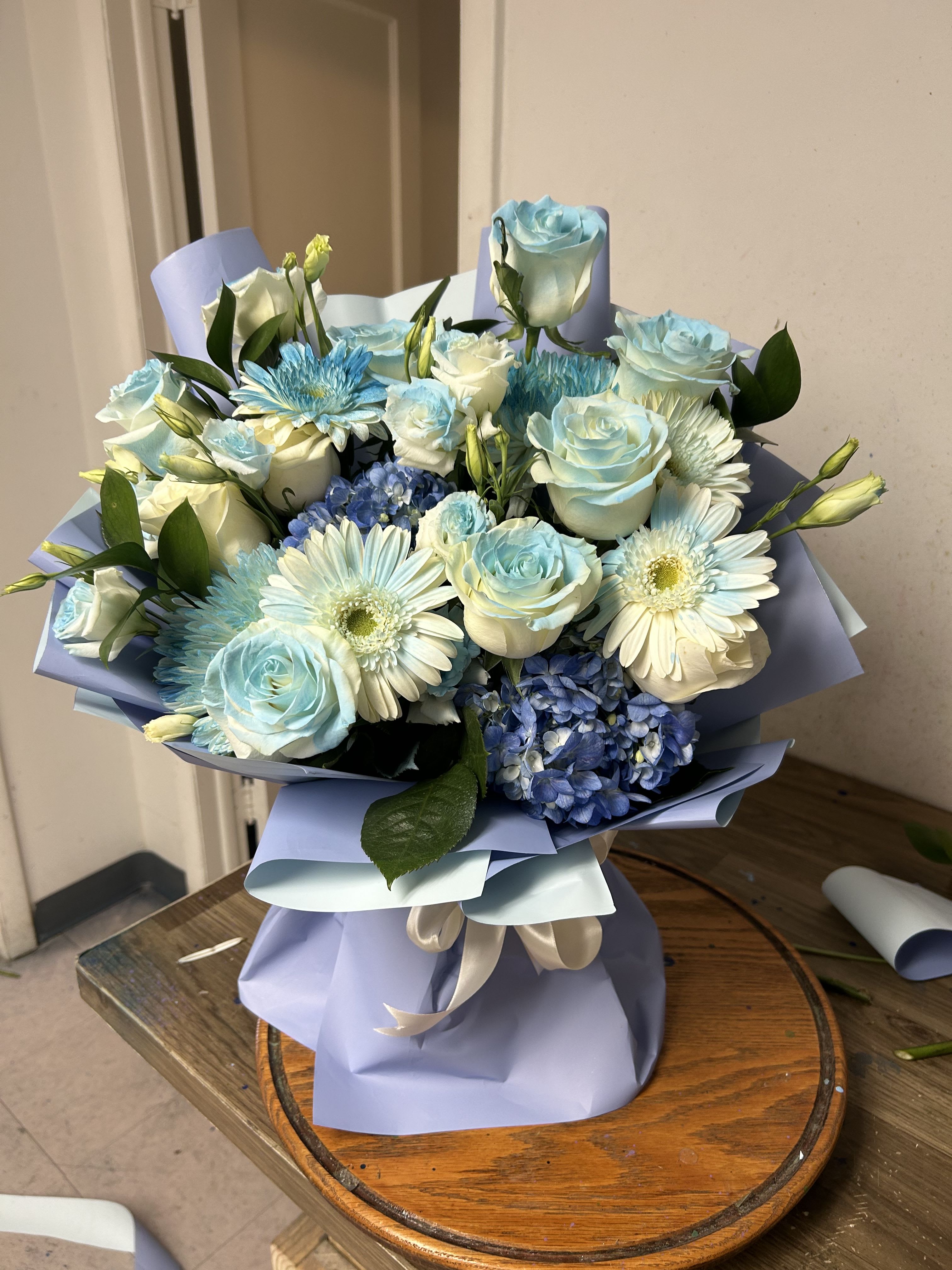 Juliana’s flowers design  - Floral arrangement in light blue colors and foliages
