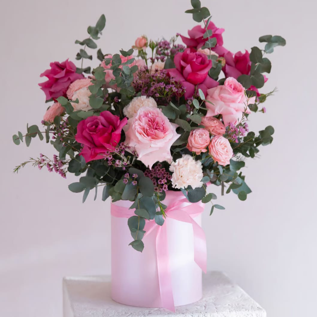 Spring Flowers in a Box - Celebrate love and elegance with this stunning arrangement of pink and blush tones, designed to leave a lasting impression. Perfect for romantic gestures, birthdays, or simply to brighten someone's day, this luxury bouquet features a harmonious blend of fresh flowers, artfully arranged in a chic round gift box with a satin ribbon bow.  Whether you're in Los Angeles or sending a heartfelt gift to someone special in the area, this floral masterpiece embodies beauty and sophistication. Ideal for Valentine's Day or any special occasion, let the delicate blooms and stylish presentation add a touch of romance to your loved one's life.