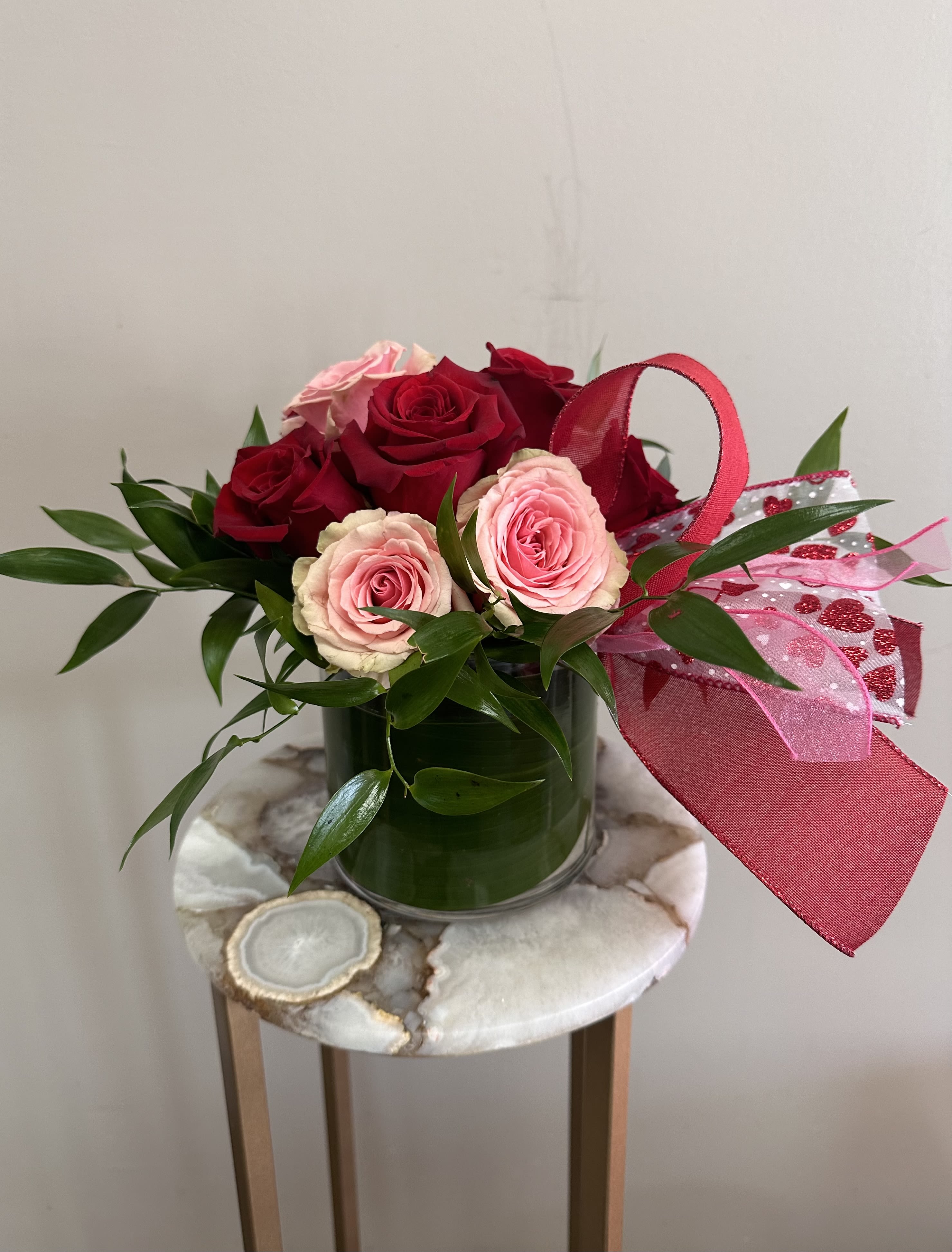 Adore Me - A short and modern styled arrangement of red and pink roses. The perfect Anniversary or Valentine's Day addition.