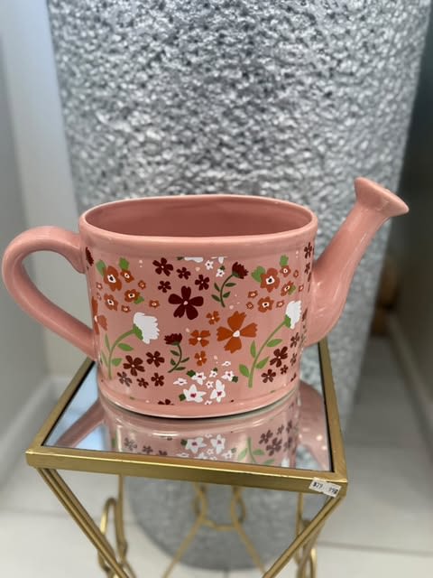 Blush Bloom Watering Can Blush Bloom Watering Can - A charming pink ceramic watering can with floral accents, perfect for adding a whimsical touch to your space.
