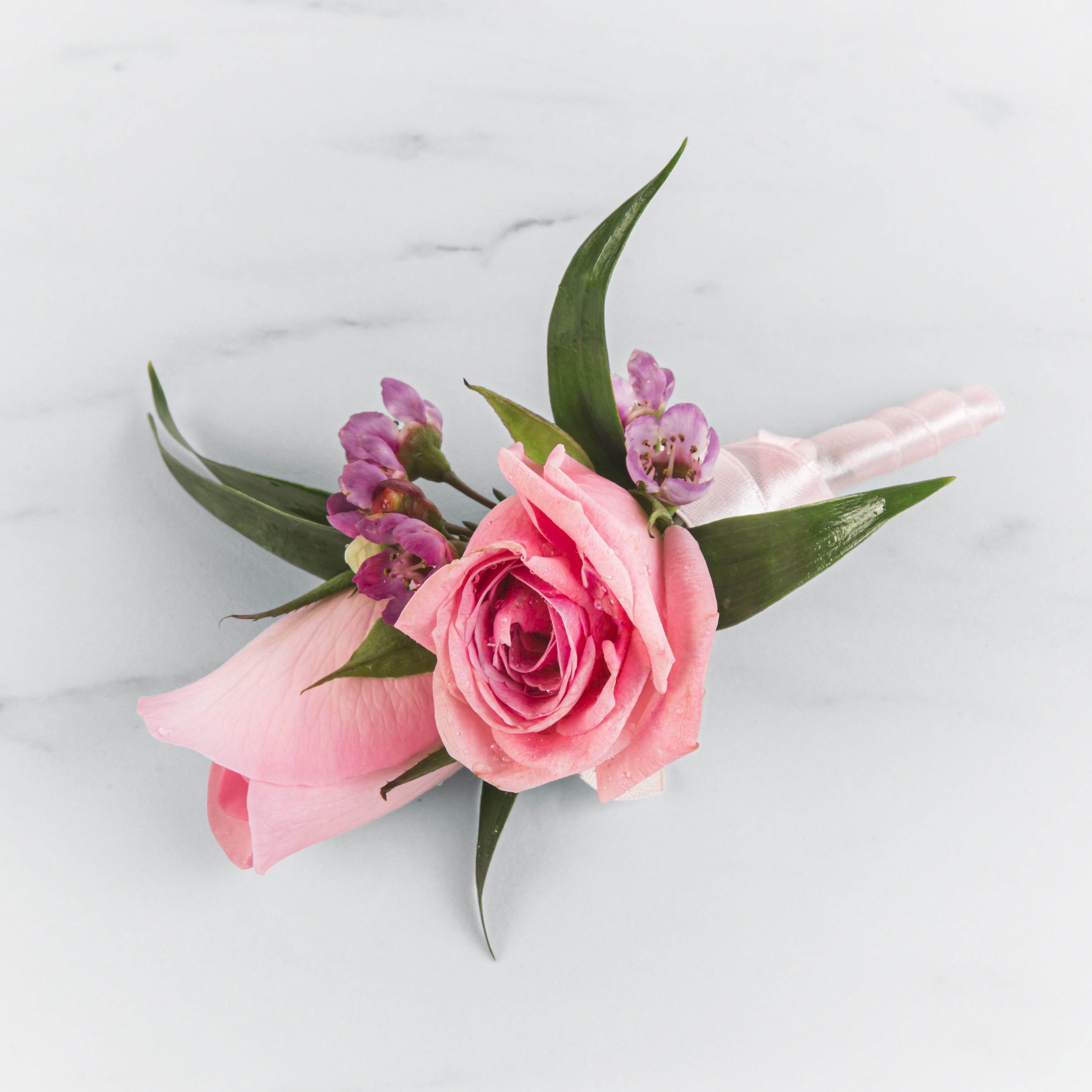 Pink Rose Boutonnière by BloomNation™ Pink Rose Boutonnière by BloomNation™ - A classic pink rose boutonnière that compliments any suit. A perfect addition to any prom, formal, or wedding event.