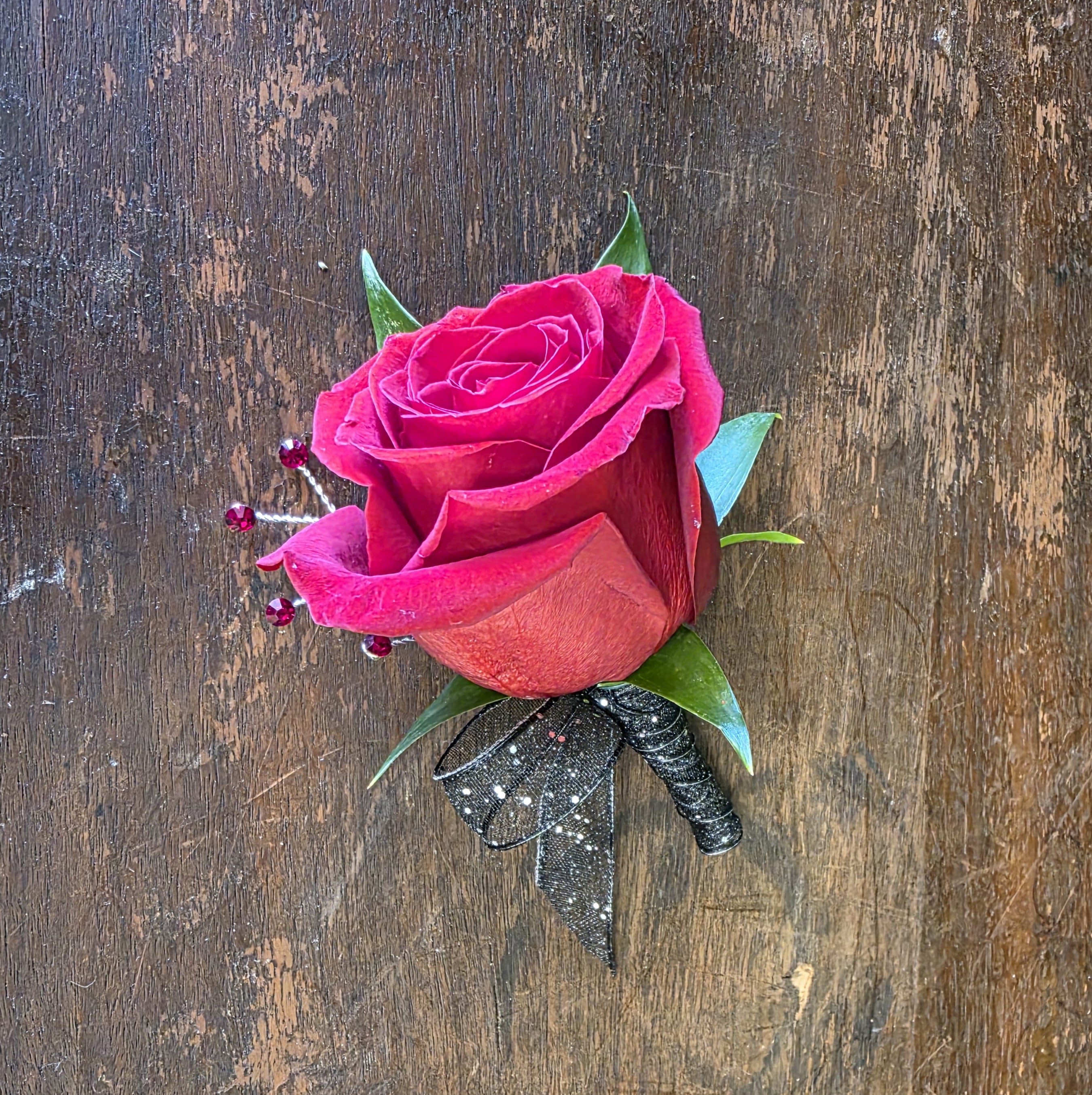 Red Rose Boutonniere - Red Rose Boutonniere With Black Sparkle Ribbon, Red Rhinestones And Greenery.
