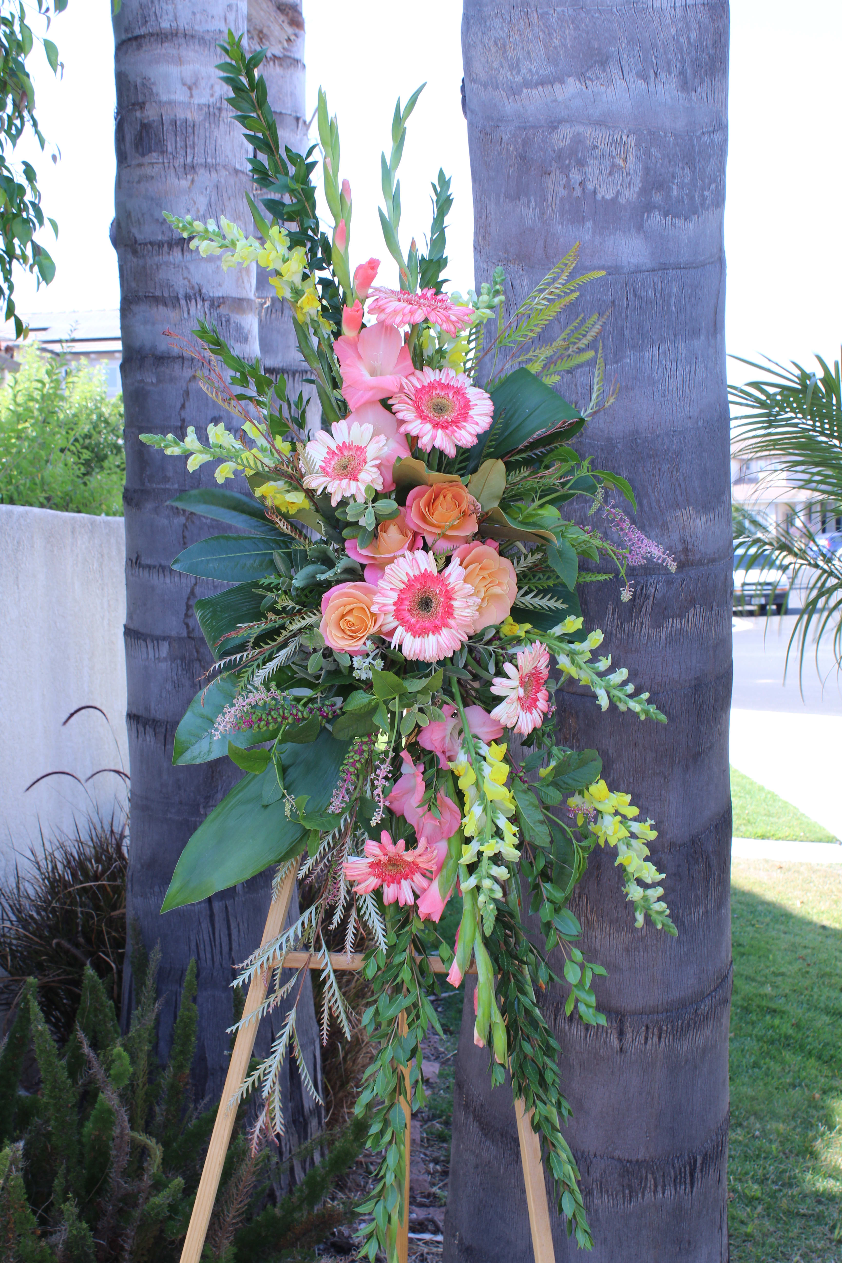 Medium Easel for Funeral - Medium sized easel arrangement with gladiolas, roses, snapdragons, Gerber's and magnolia leaves. 
