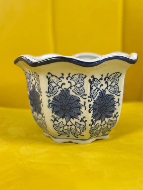 Azure Bloom Ceramic Planter Azure Bloom Ceramic Planter - A timeless blue and white porcelain planter featuring an intricate floral motif. Perfect for adding an elegant touch to your home decor while beautifully displaying your favorite plants or flowers.