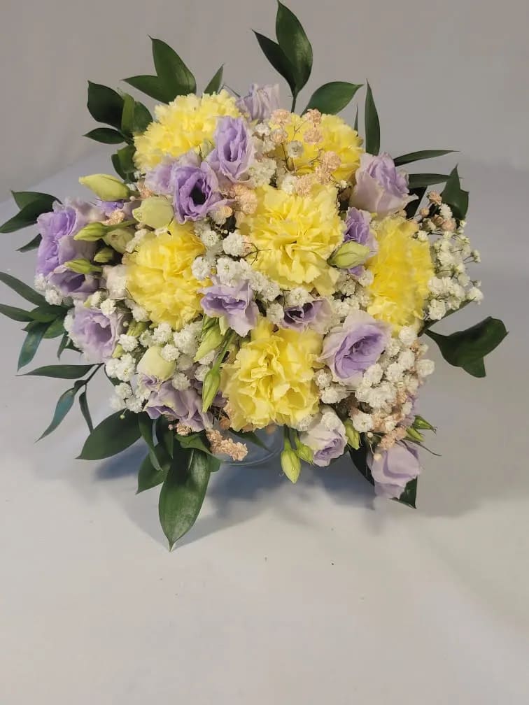 Lavender Lisianthus & Yellow Carnation Handheld Bouquet Lavender Lisianthus & Yellow Carnation Handheld Bouquet - Beautiful bouquet for Prom, Homecoming or Wedding. Hand-tied with Lavender ribbon. Lavender Lisianthus, Yellow Carnations, White Baby's Breathe, Light Pink Baby's Breathe and Ruscus Greenery.
