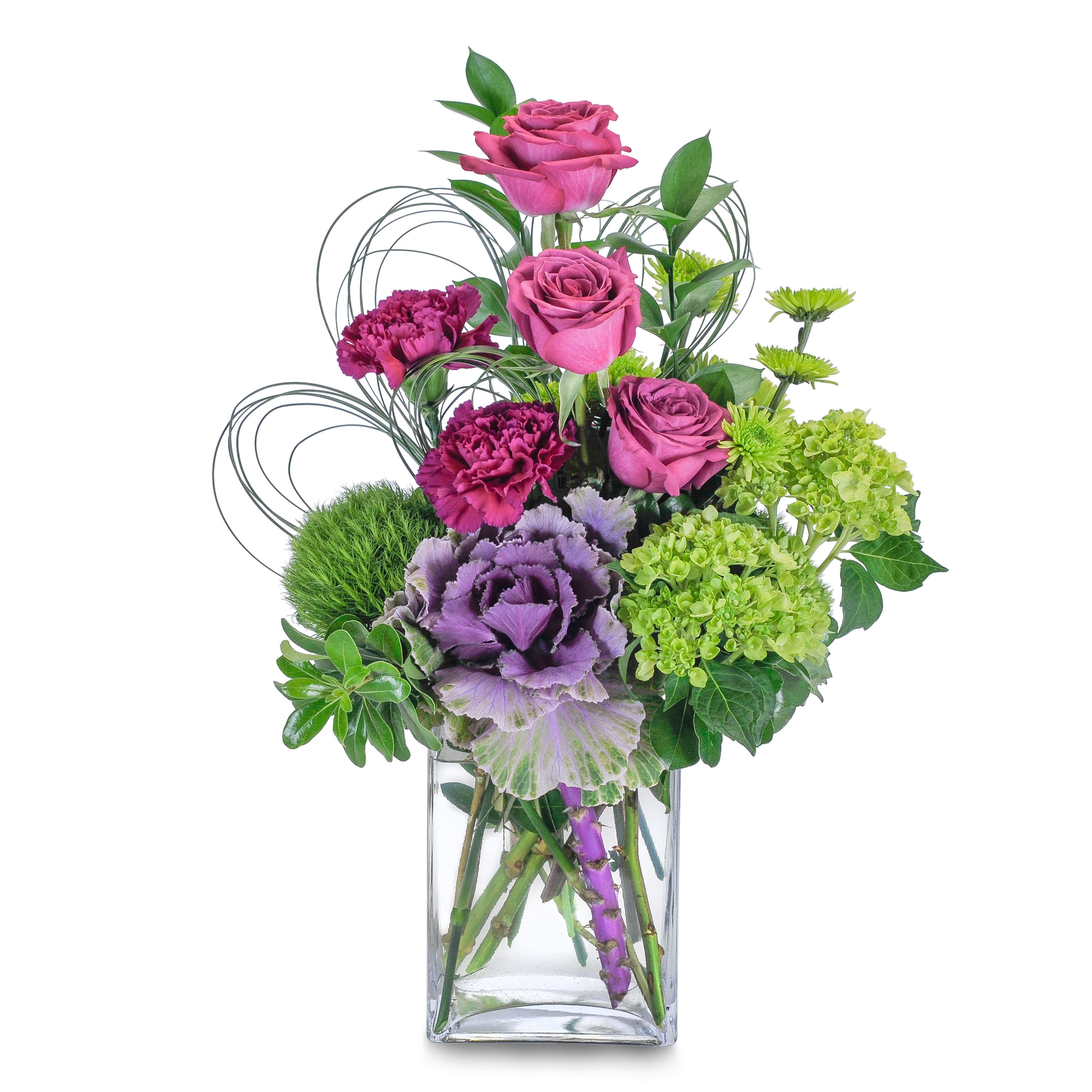 Magenta Sky - TMF-197 - &quot;A stunning mix of magenta and green flowers, including roses, hydrangea, hypericum berry and ornamental kale, designed in a clear glass vase. The loops of bear grass shelter, and add extra interest and a delicate touch to the beautiful blooms.   Purple roses, green hydrangea, and ornamental kale are designed in a clear glass vase and accented with premium foliage.&quot; Approximately 18&quot;H X 10&quot;W