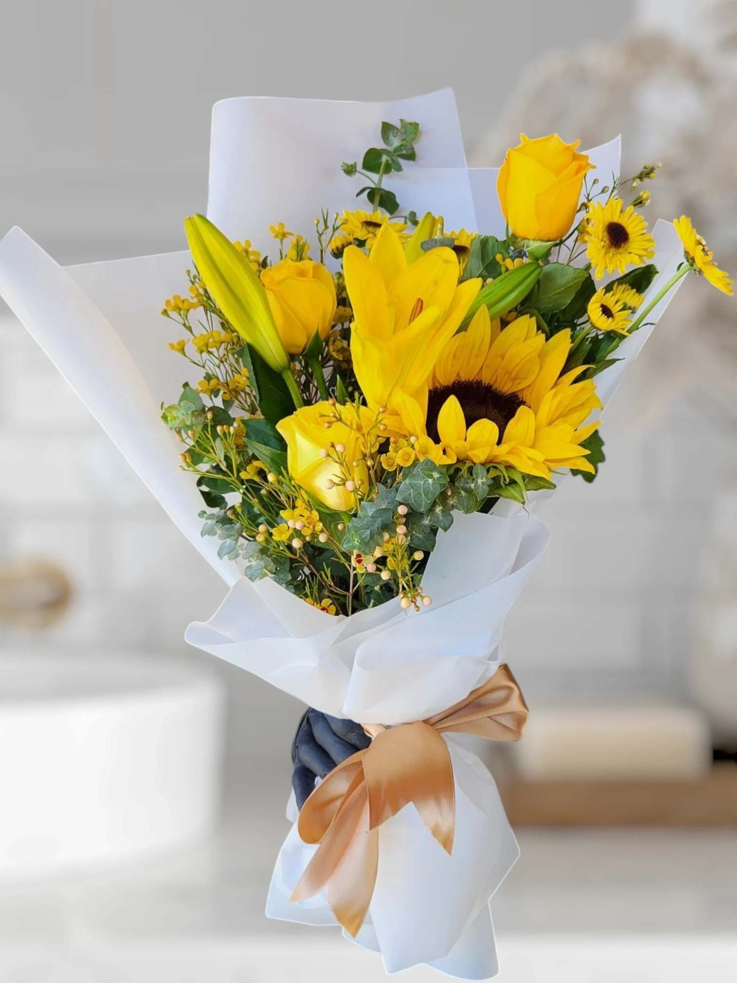 Yellow Bouquet  - Yellow roses, sunflowers, Lilies and a variety of Yellow flowers.  Yellow Flowers represent Spring.  Spring is widely recognized as a season of new beginnings, symbolizing renewal and growth, both in nature and in human lives