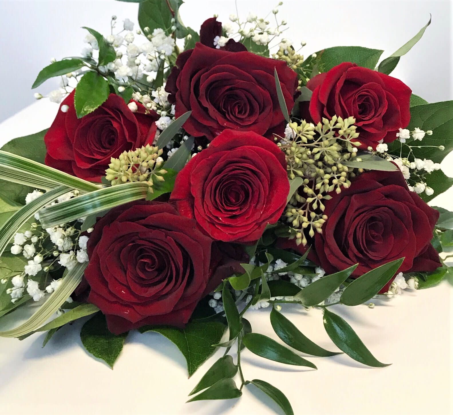 Half-Dozen Rose Wrap - Six beautiful long-stemmed roses in your choice of color with the works. Please indicate color choice in the special instructions. If no color is specified red will be chosen unless sold out, then we will choose the color for you.