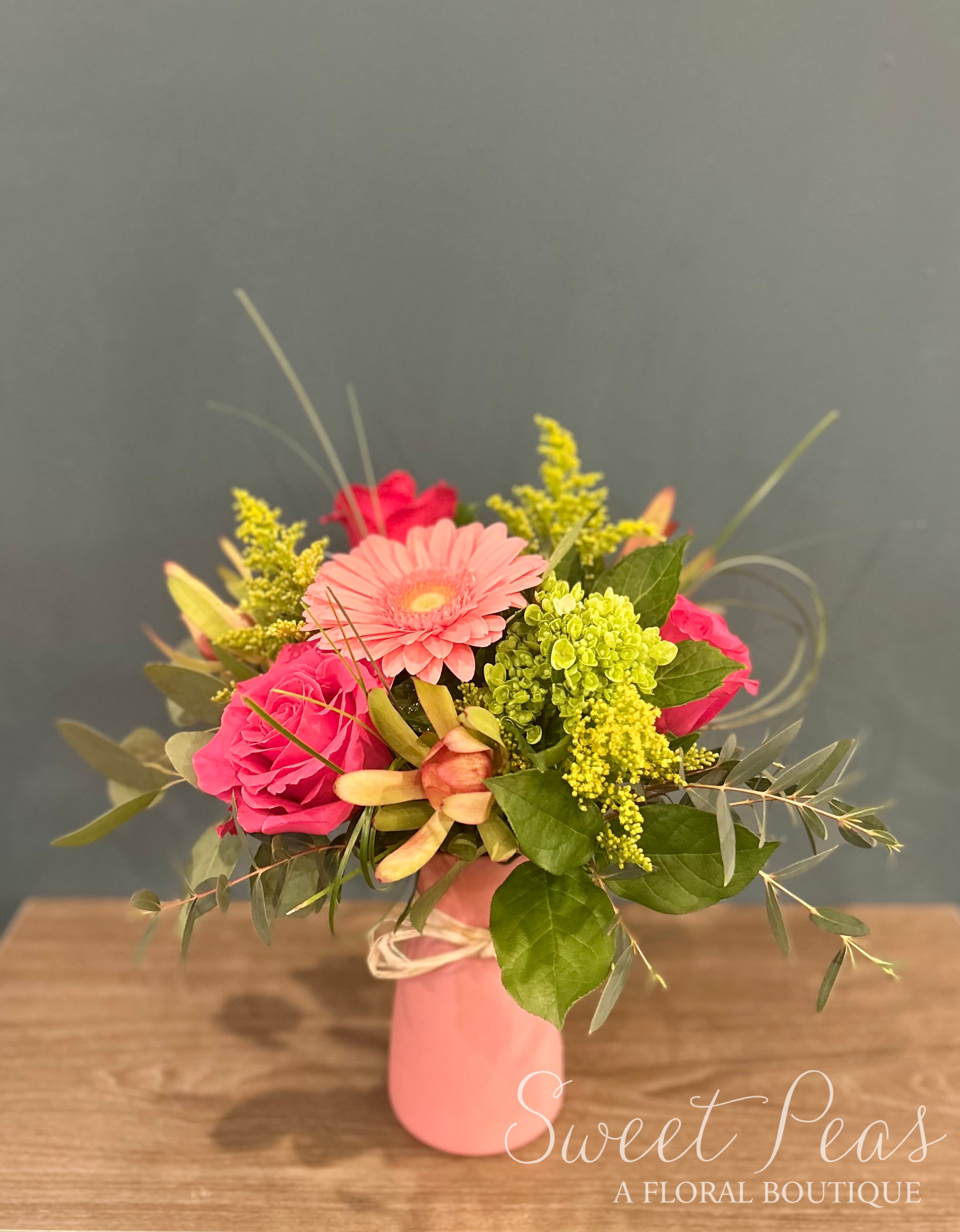 Pink Lemonade Pink Lemonade - A sweet summertime mix of pinks and yellows including gerbera daisy, roses, leucadendron and solidago. Great for a little pick me up. Approx. 18" Tall x 12" Wide