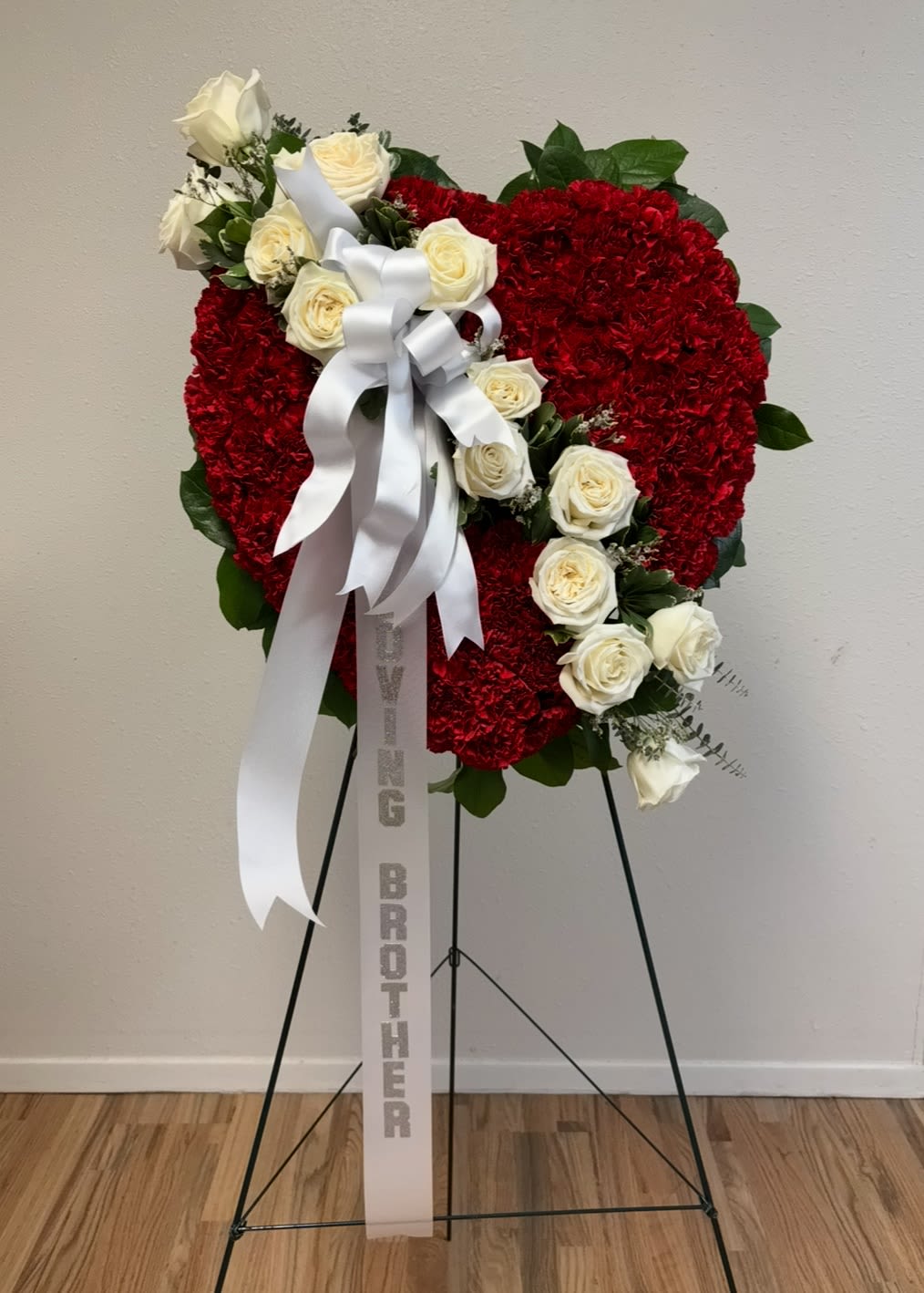 Grey House Blooms-Broken Hearts - Oasis Floral Foam Solid Heart design covered in Red Carnations with a White Rose divider indicating a Broken Heart.  The Solid Heart comes in a 12, 18 or 24 inch size. 