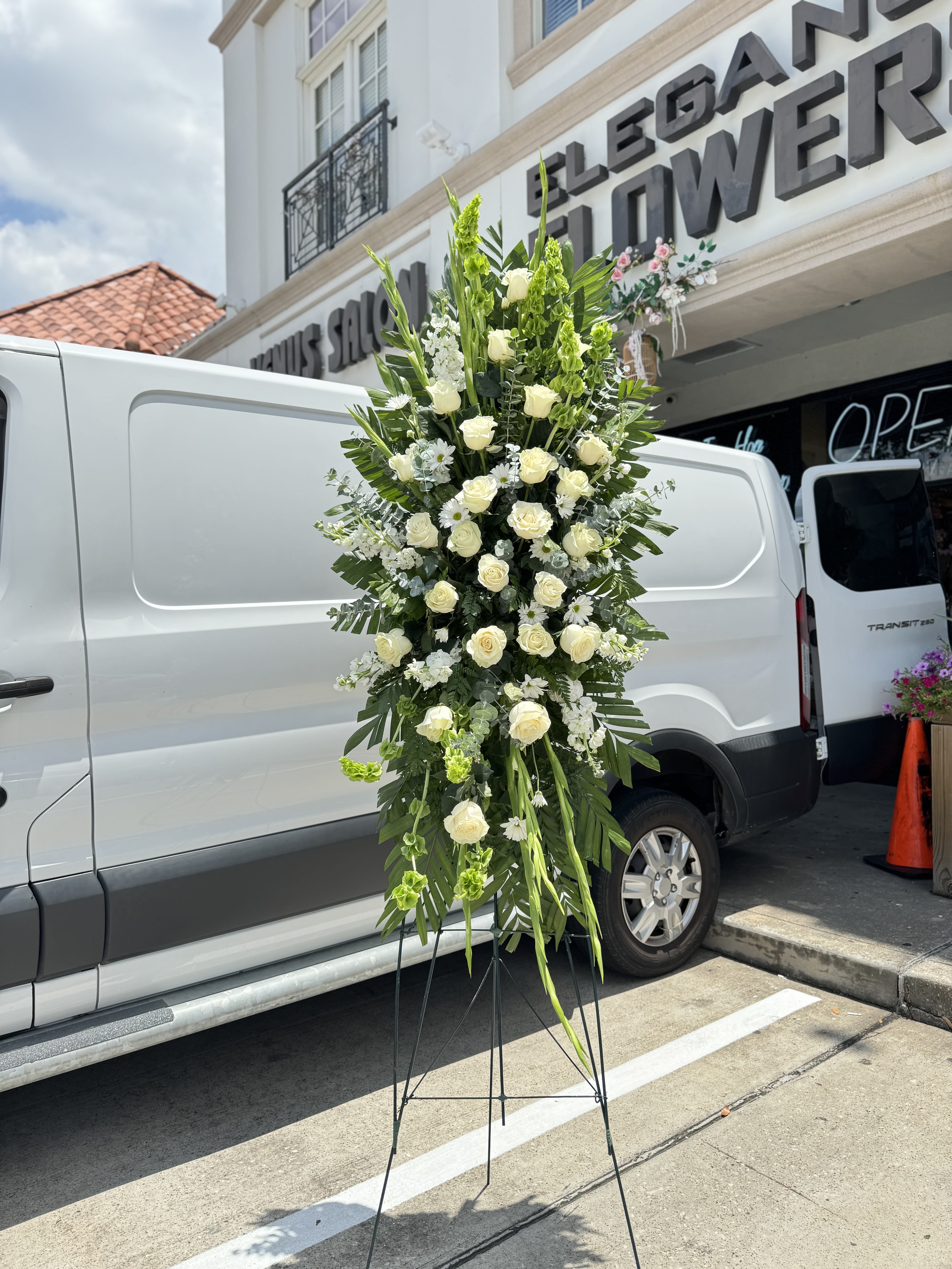 Easel #17 Online Easel #17 Online - A standings flower arrangement for a funeral service is a heartfelt tribute designed to honor and celebrate the life of the deceased. These arrangements are typically displayed on an easel or stand, making them highly visible and a central part of the memorial decor.