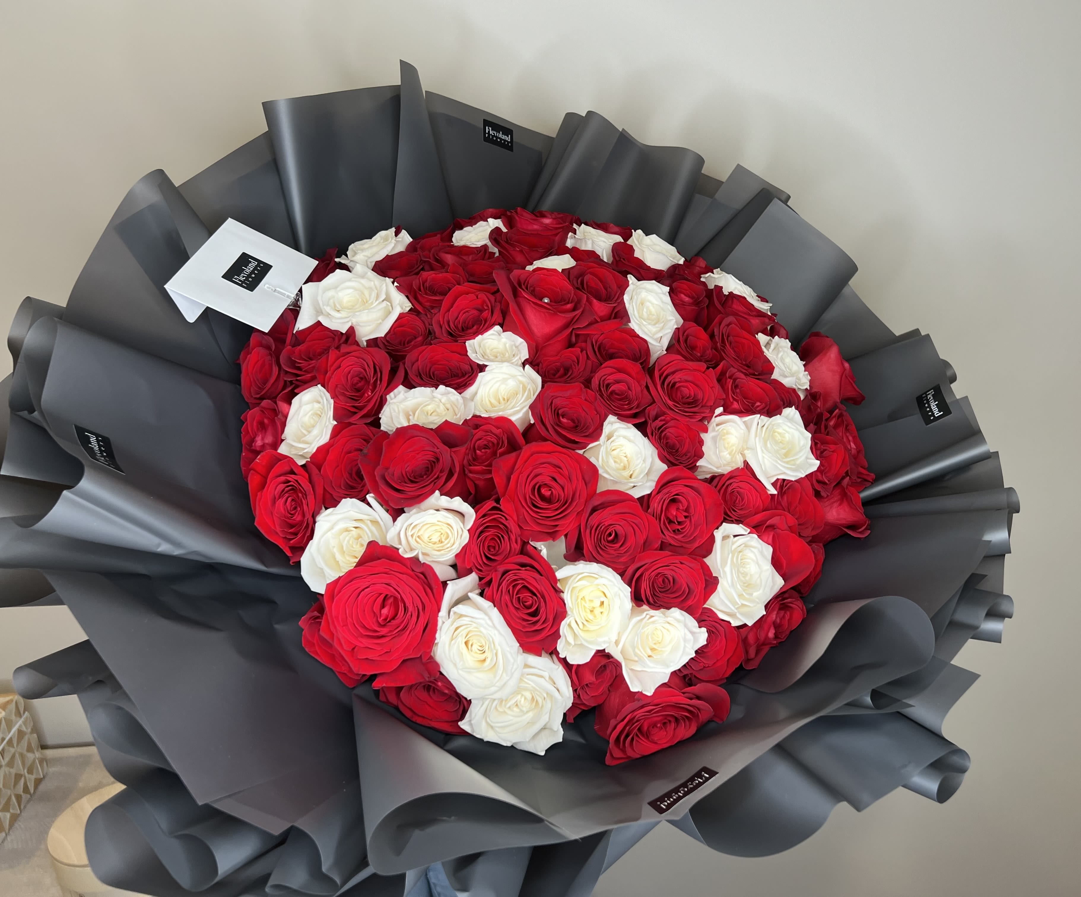 A Stunning Display of Love  - A breathtaking arrangement of 100 red and white roses, blending passion and purity in one beautiful bouquet. Perfect for expressing deep emotions and making a lasting impression. Ideal for grand celebrations, special moments, or as a gift that speaks volumes. Each rose conveys a unique message of love, respect, and admiration.