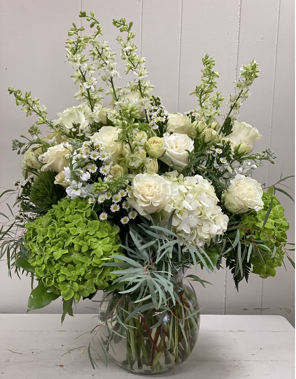 The Crescent Cove The Crescent Cove - This show stopper vase will wow everyone. Its filled with lush roses and hydrangeas and enhanced with larkspur, accent flowers and eucylptus. What a stunning arrangment of fresh blooms.