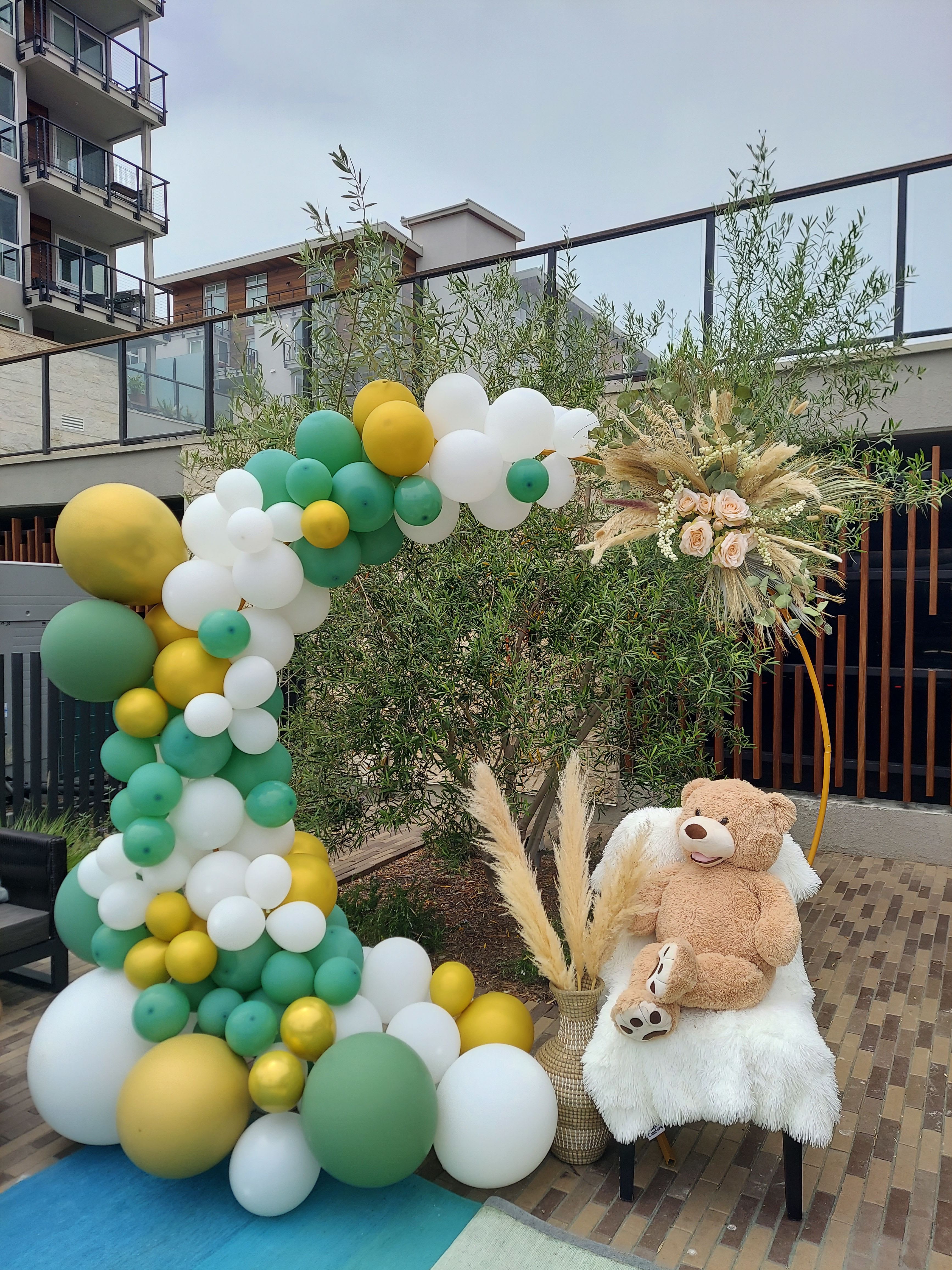 Boho Bear Balloon Arch - Step into a serene celebration with the Boho Bear Balloon Arch, featuring the beloved Taddy Bear. Designed in an elegant palette of green, gold, and white, this arch embodies the perfect balance of boho chic and timeless elegance. Whether for a baby shower, birthday, or special event, Boho Bear  Balloon Arch brings a sense of natural beauty and warmth, creating a stunning centerpiece that captures the essence of your celebration.