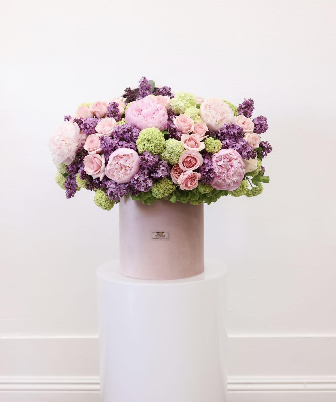 Vinca  - The arrangement includes the following flowers; peonies, lilacs, spray roses and hydrangea.
