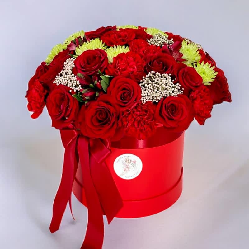 Love In Bloom #32 - This stunning arrangement of deep red roses and carnations, nestled in a large red hot box, is a visual symphony of love and romance. Meticulously crafted with care and artistry, each flower is a testament to the intensity of your emotions. Order now for this timeless expression of love. Secure this exquisite bouquet to create lasting memories for your special someone on this romantic occasion.