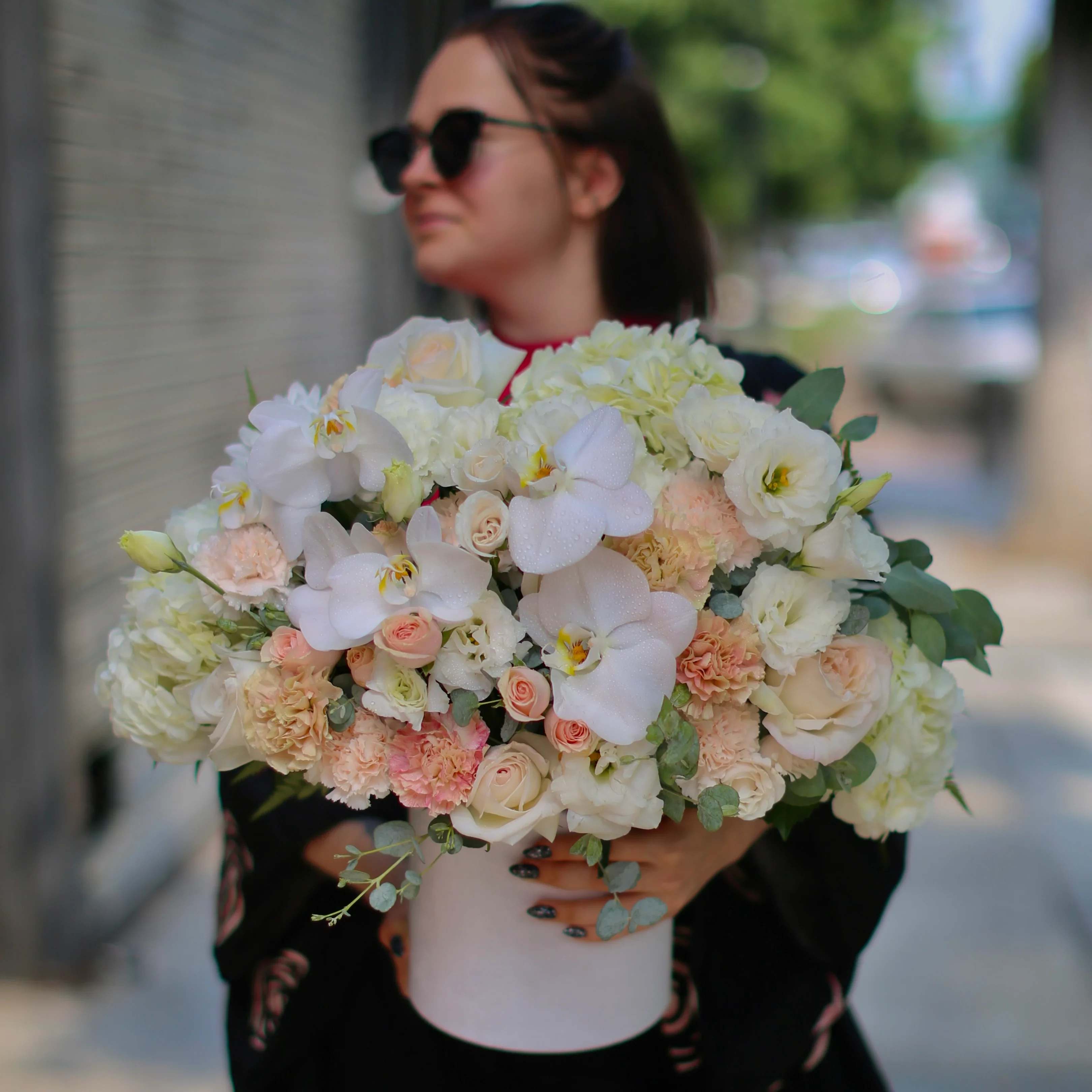 Cora - Cora is a floral arrangement of beige orchids, garden roses, hydrangea, carnation and some greenery in a box. Perfect for any occasion. 